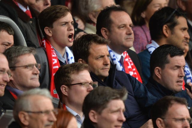 Tim Sherwood watches Tottenham's 4-0 defeat by Liverpool last weekend from the stands
