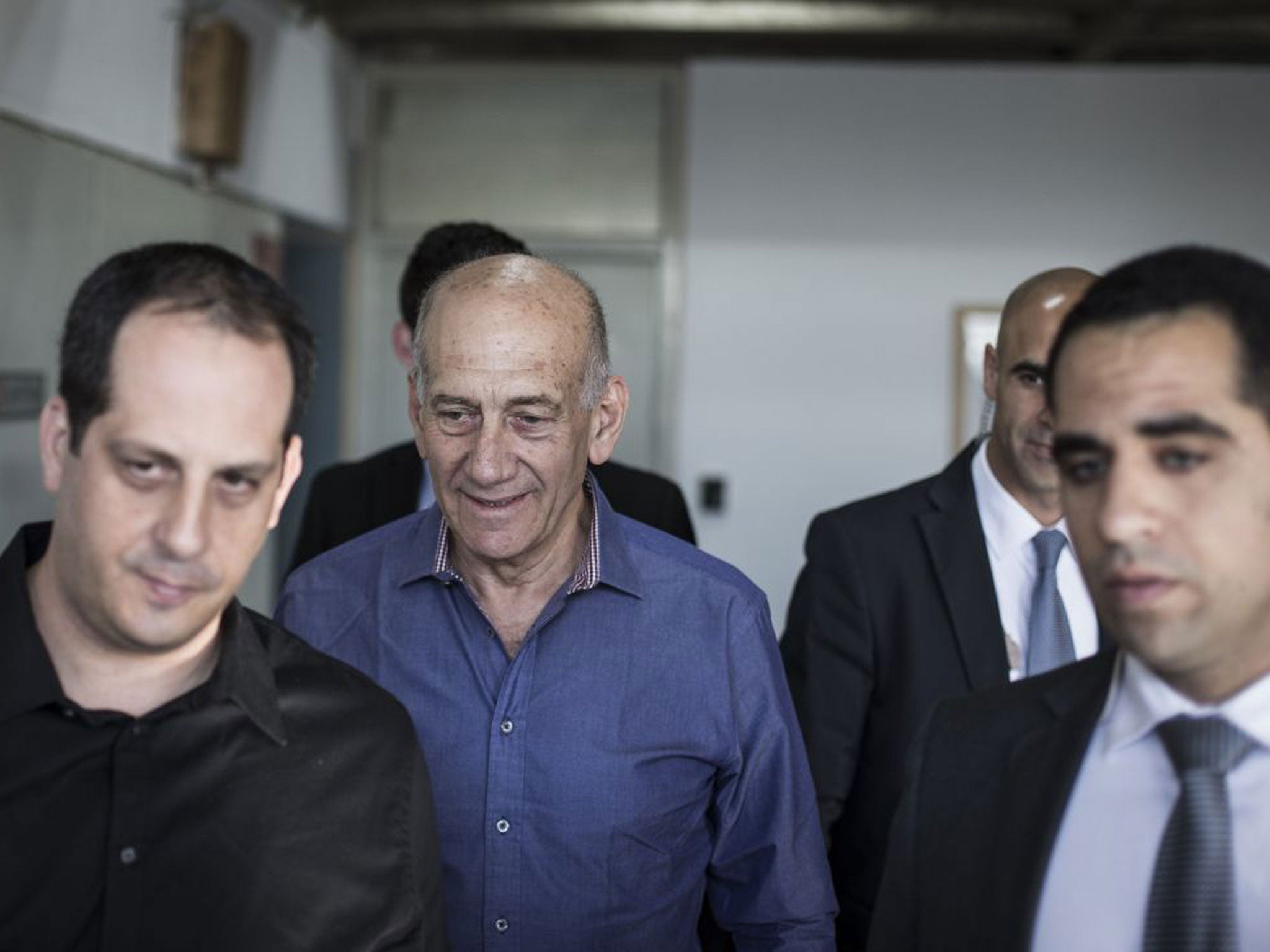 The former Israeli Prime Minister, centre, arrived in court to face charges related to his time as Mayor of Jerusalem