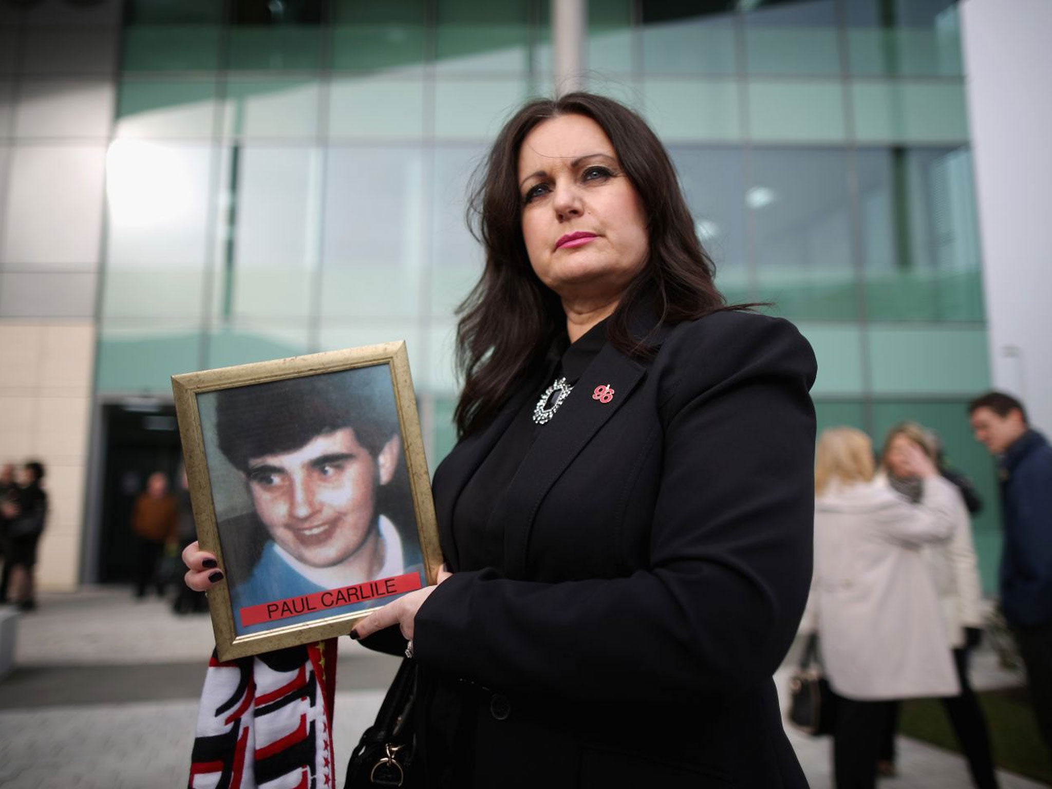 Donna Miller, carrying a picture of her brother Paul Carlile, who died aged 19 at Hillsborough, arrives for the start of the new inquest