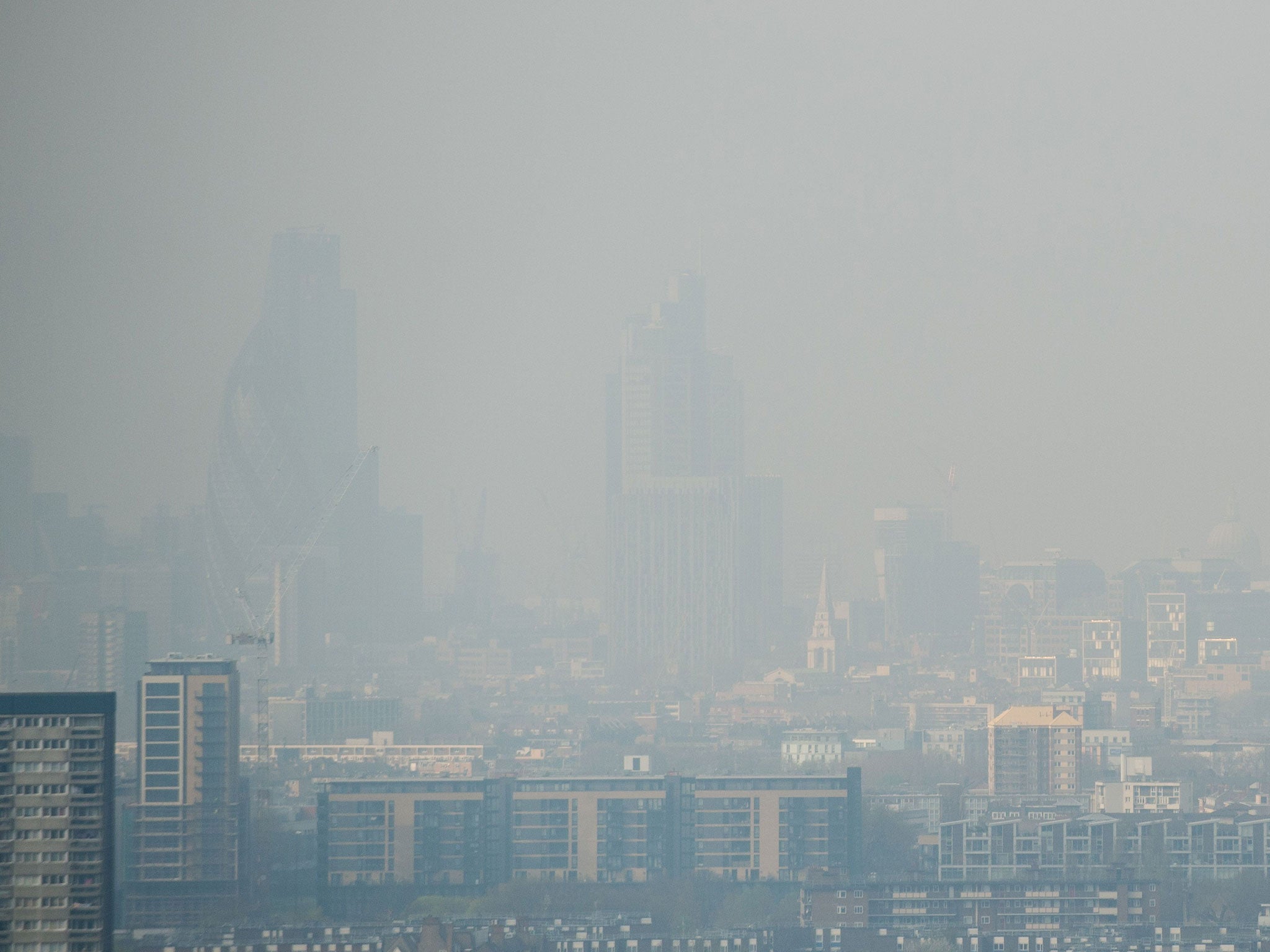 Air pollution hangs in the air lowering visibility towards central London and the City from east London