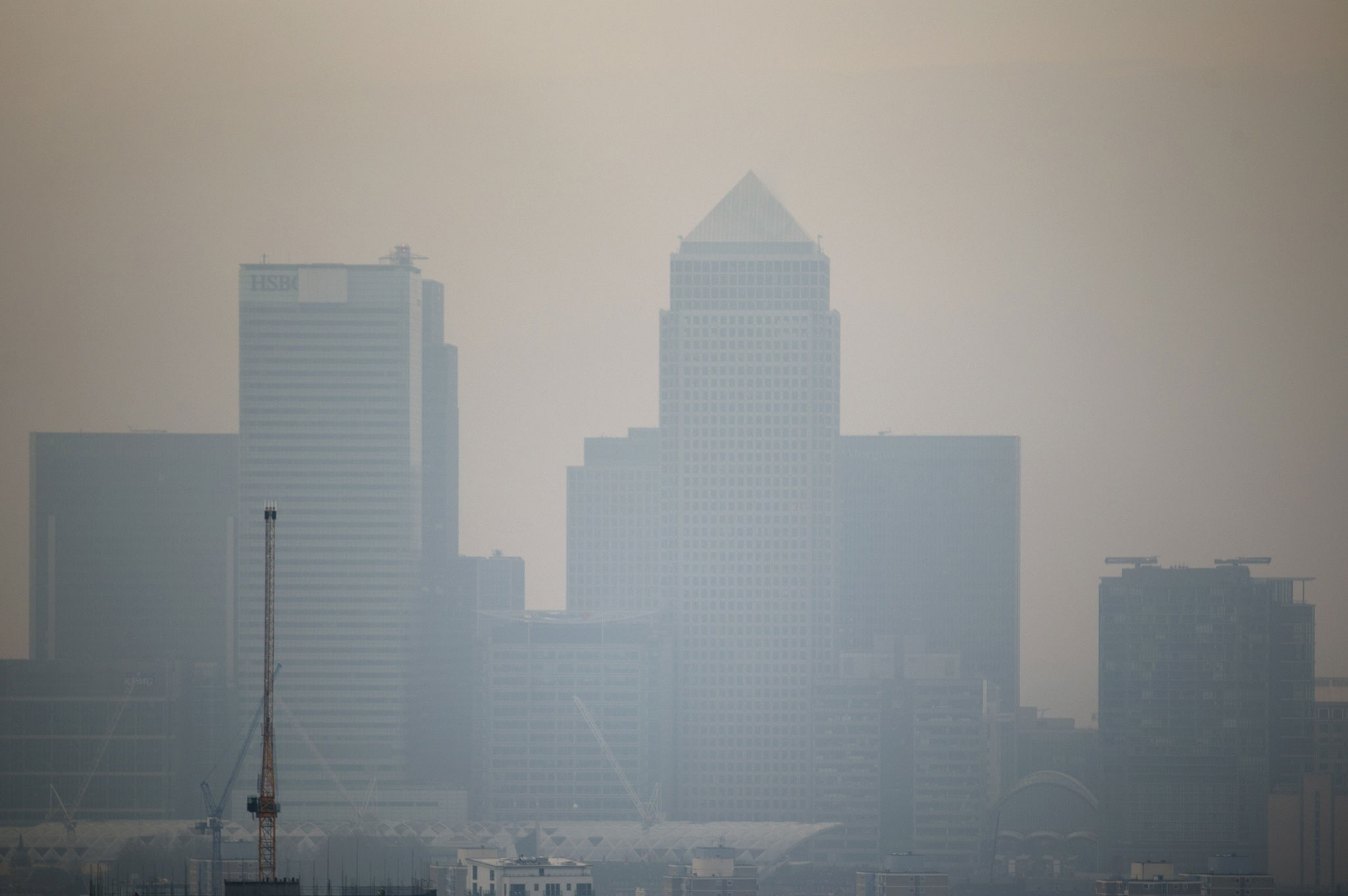 Skyscrapers of the Canary Wharf business district in London shrouded in smog
