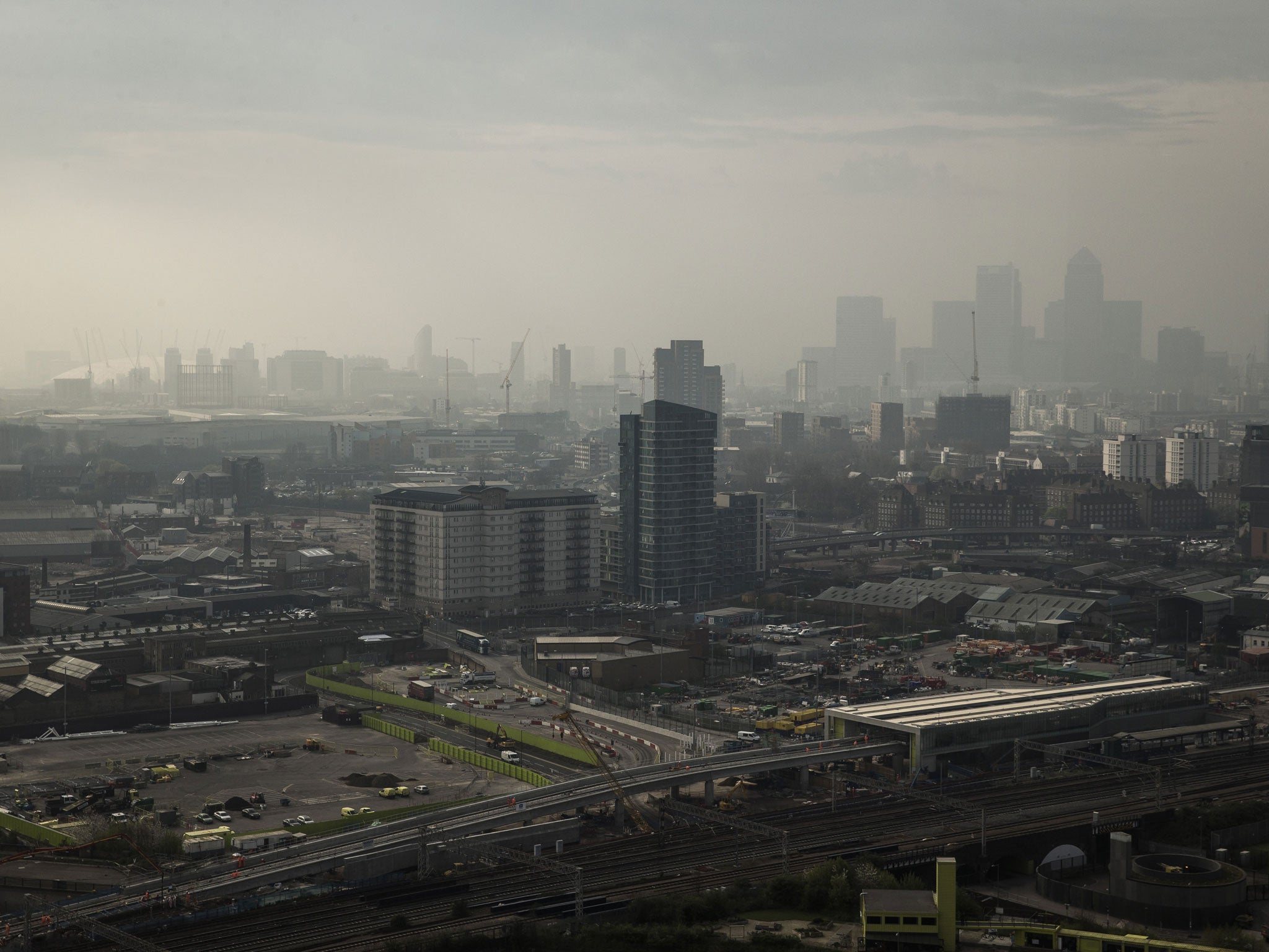 A view through smog over the 02 Arena and the Canary Wharf financial district in London.