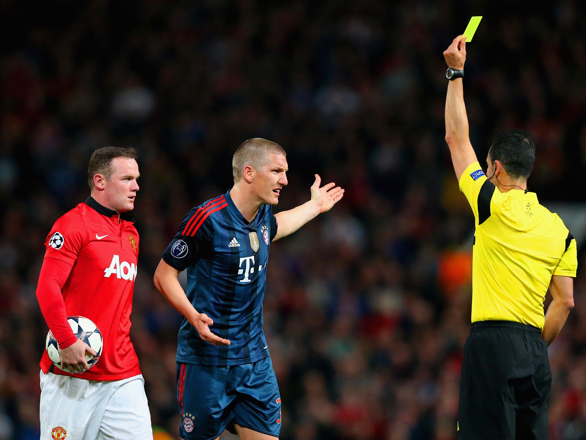 Bastian Schweinsteiger is shown a yellow card during the 1-1 draw between Manchester United and Bastian Schweinsteiger