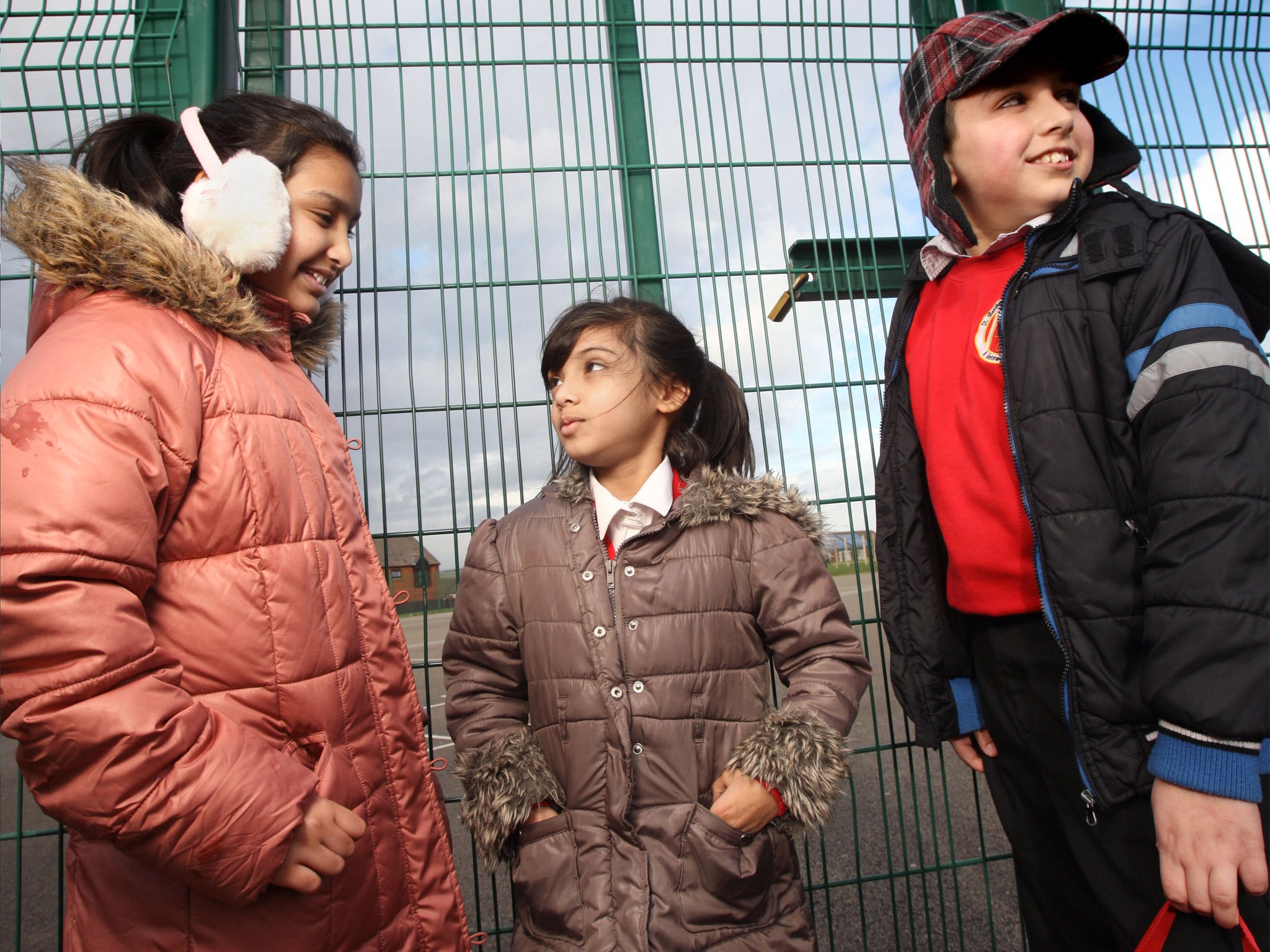 Pupils wait outside the gates at St Matthew's school in Blackburn (Guzelian)