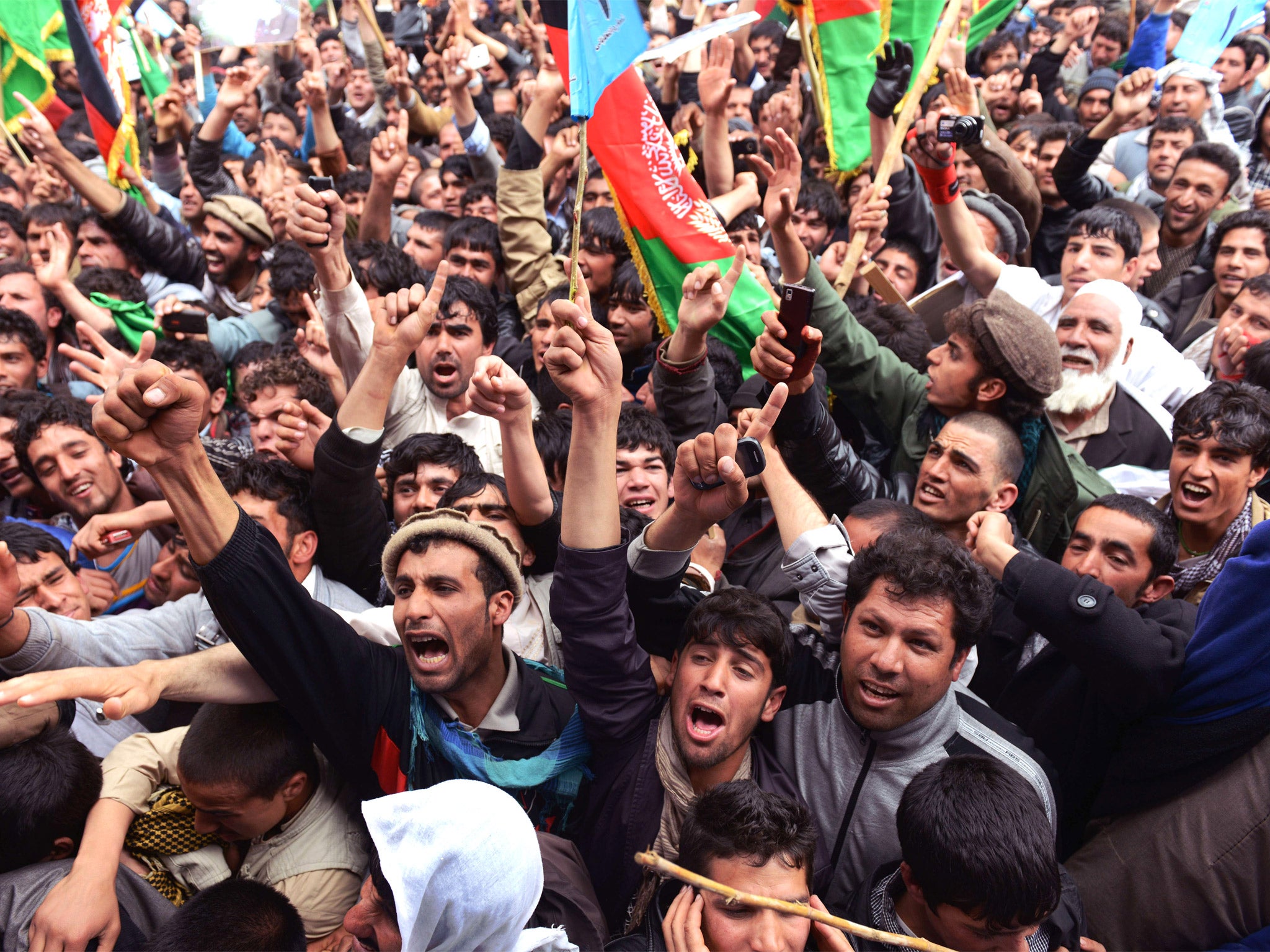 Supporters cheer presidential candidate Abdullah Abdullah during an election rally on the outskirts of Kabul