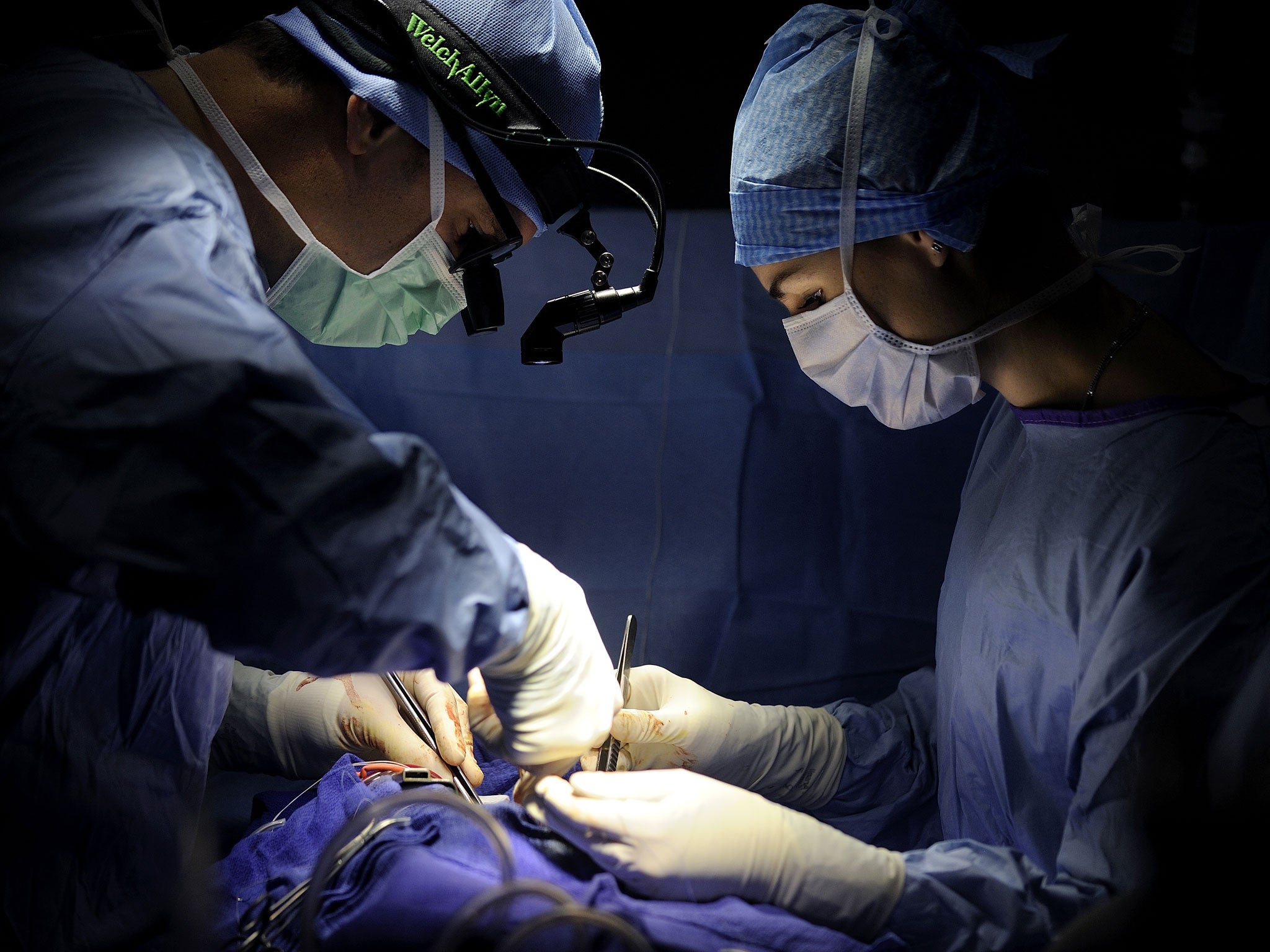 Surgeons, unrelated to the kidney transplant, perform an operation
