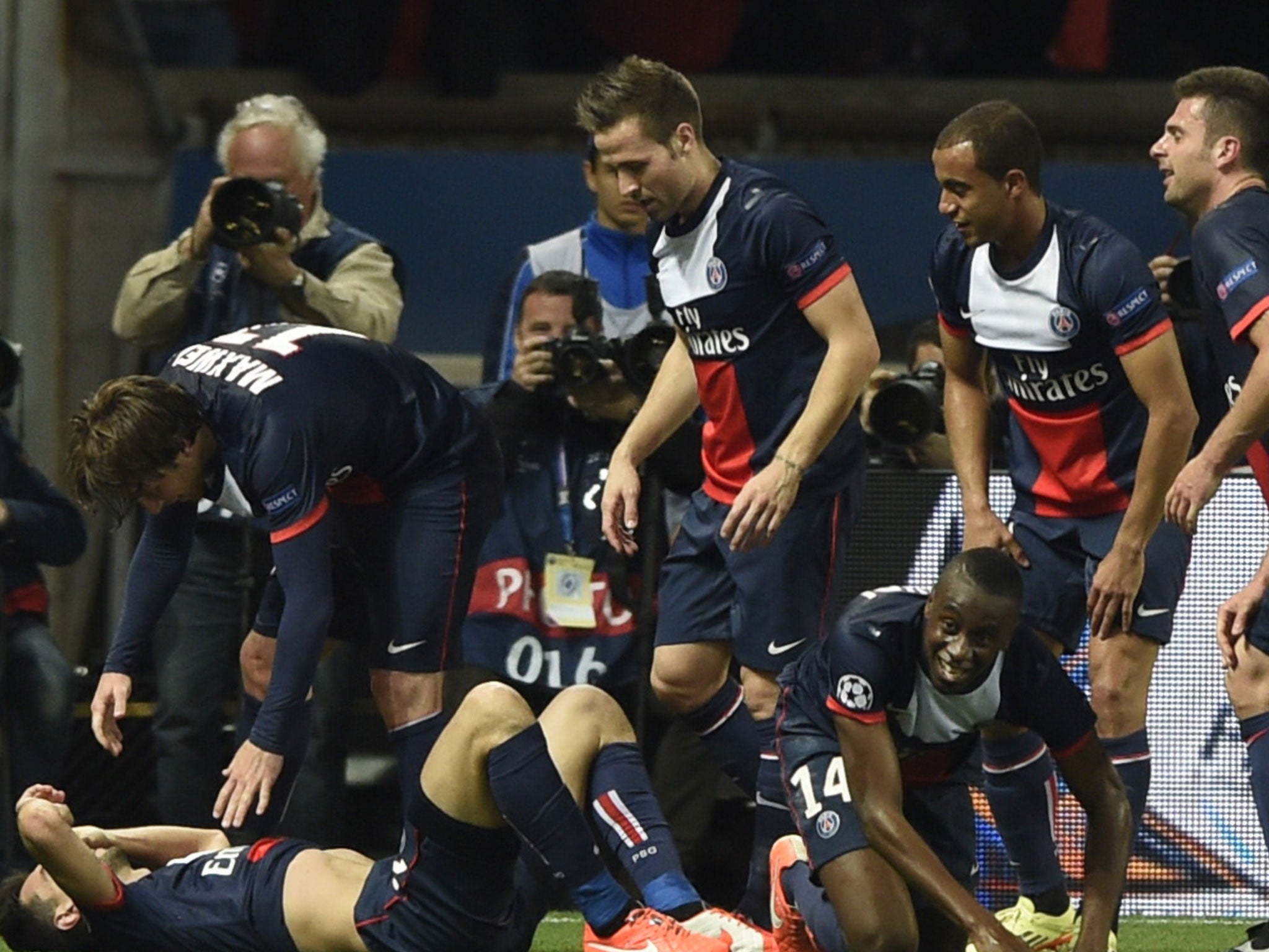 Javier Pastore (bottom left) is mobbed by his team-mates after his late strike