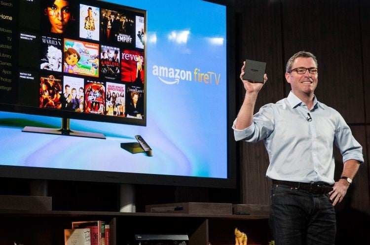 Amazon's vice president of Kindle, Peter Larsen, displays the Amazon Fire TV, a new device that allows users to stream video, music, photos, games and more through their television, on April 2, 2014 in New York City.