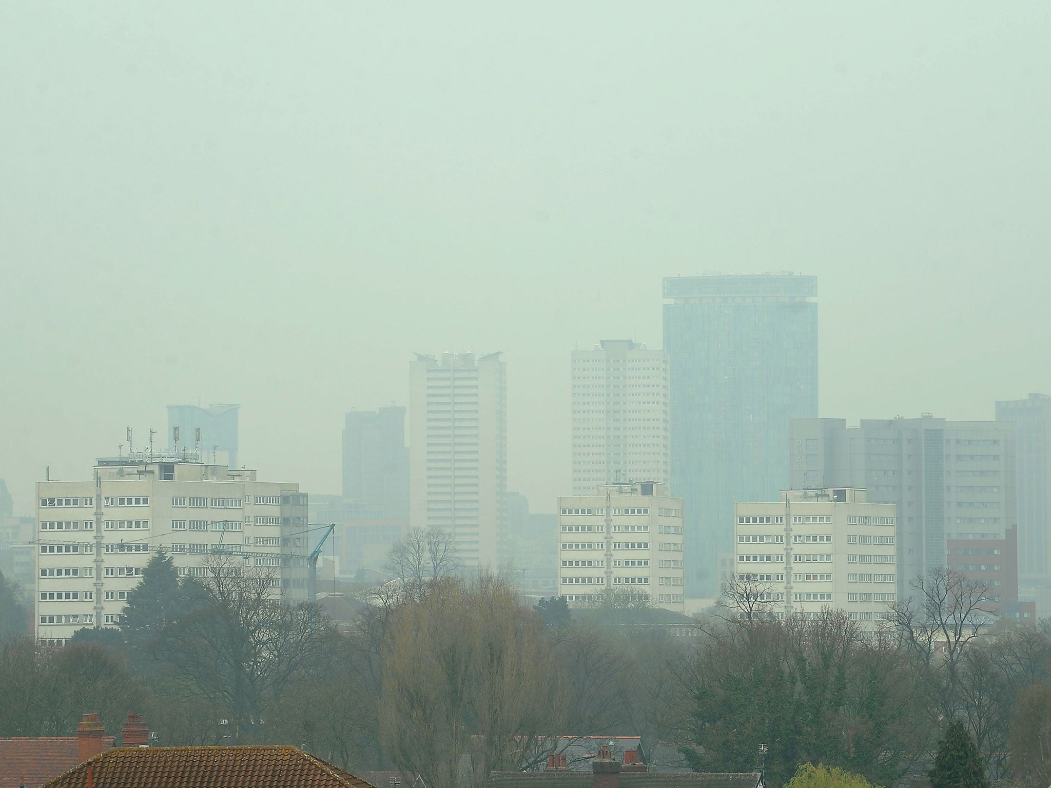 Dust particles and pollution from cars hang over Birmingham as people suffering the effects of high levels of pollution