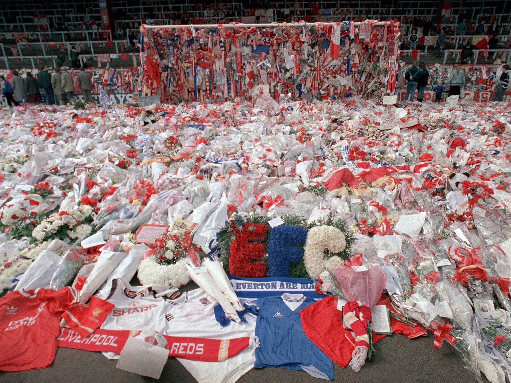 Floral tributes are placed by soccer fans at the 'Kop' end of Anfield Stadium in Liverpool on 17 April 1989 after the Hillsborough tragedy