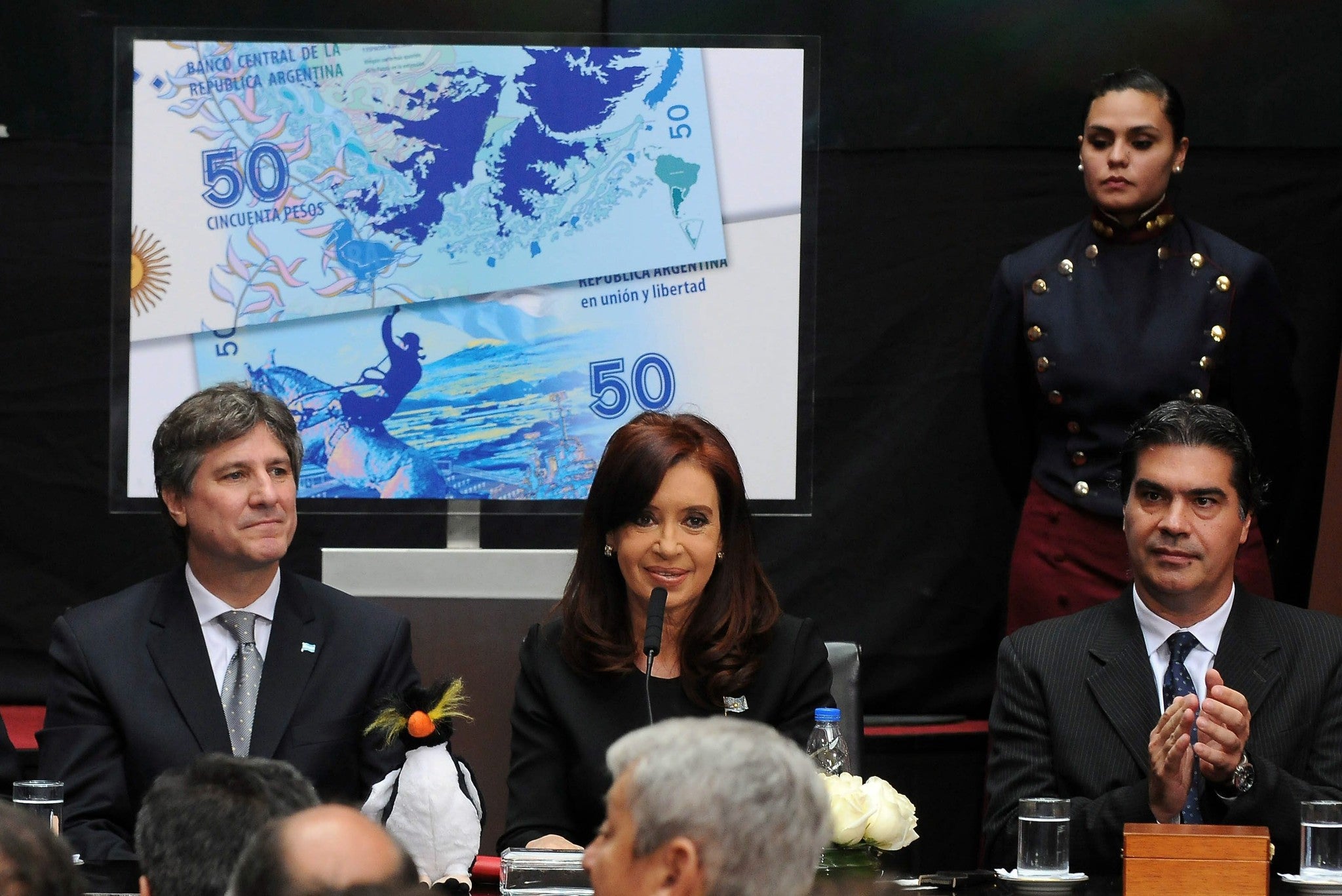 Argentinian president, Cristina Fernandez de Kirchner, next to vice president Amado Boudou (L) and representative of Government, Jorge Capitanich (R), participates in a commemoration act for the Day of War Veteran and Fallen in the Falklands war at Casa R