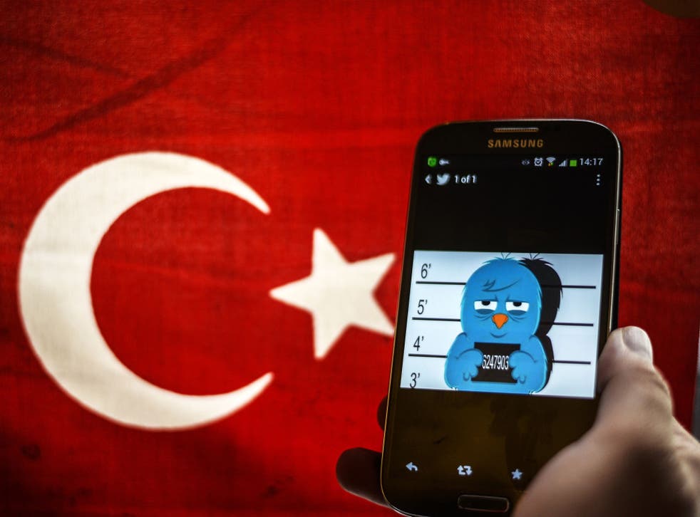 A 'mugshot' of the Twitter bird seen on a smart phone with a Turkish flag in Istanbul. Turkey's government moved on 3 April, 2014 to lift a controversial block on the social media site