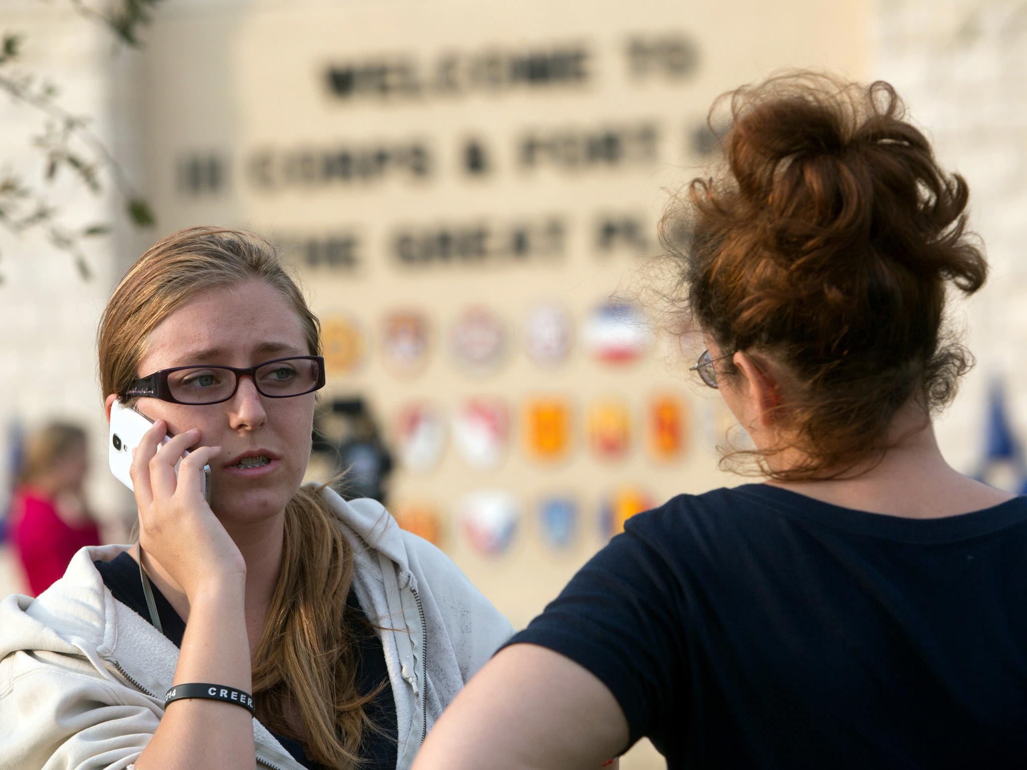 Krystina Cassidy and Dianna Simpson try to contact their
husbands, who were inside the base during the shooting