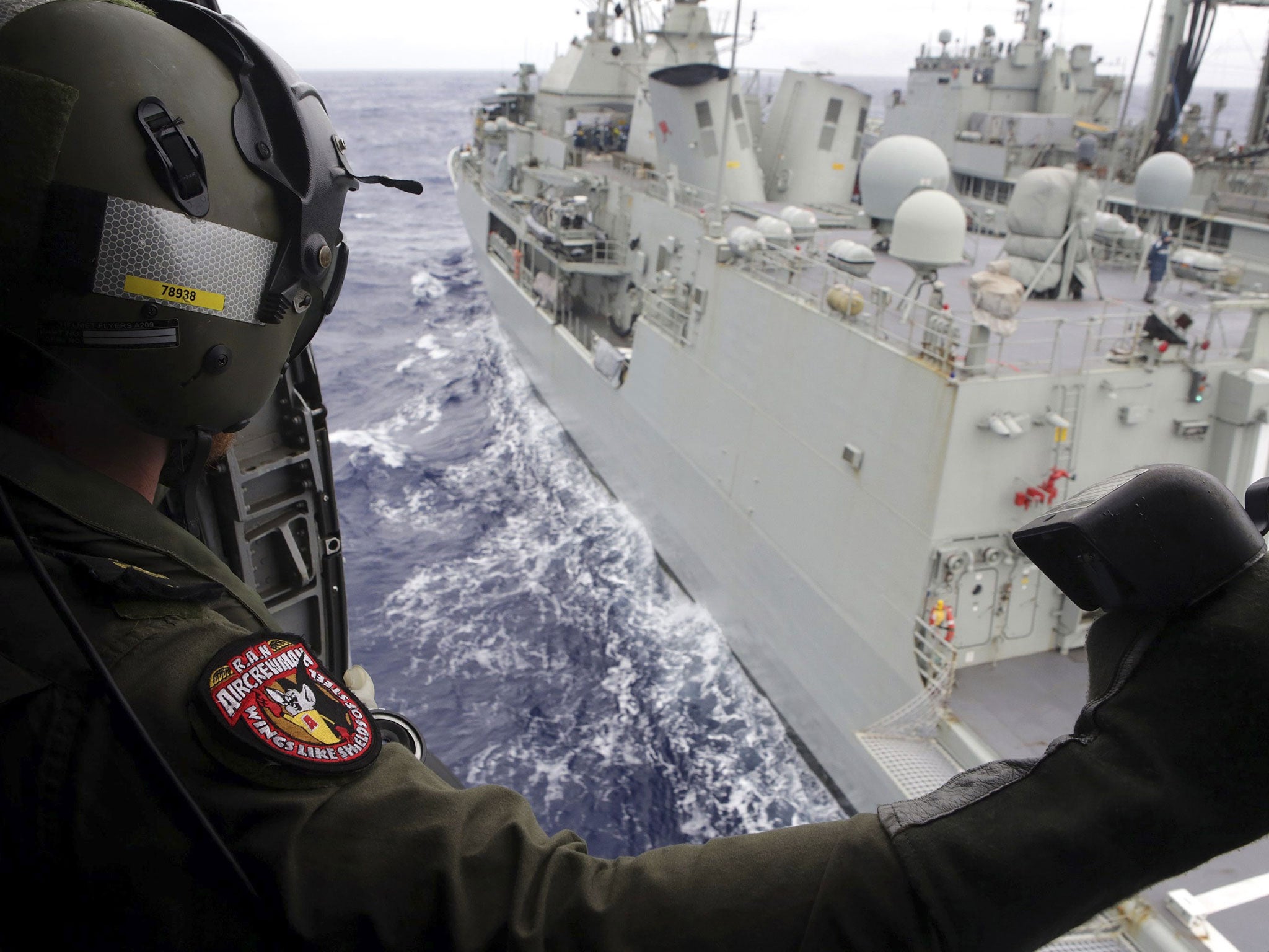 Leading Seaman Aircrewman Joel Young looks out from Tiger75, an S-70B-2 Seahawk helicopter, after it launched from the Australian Navy ship the HMAS Toowoomba as it continues the search in the southern Indian Ocean for the missing Malaysian Airlines fligh