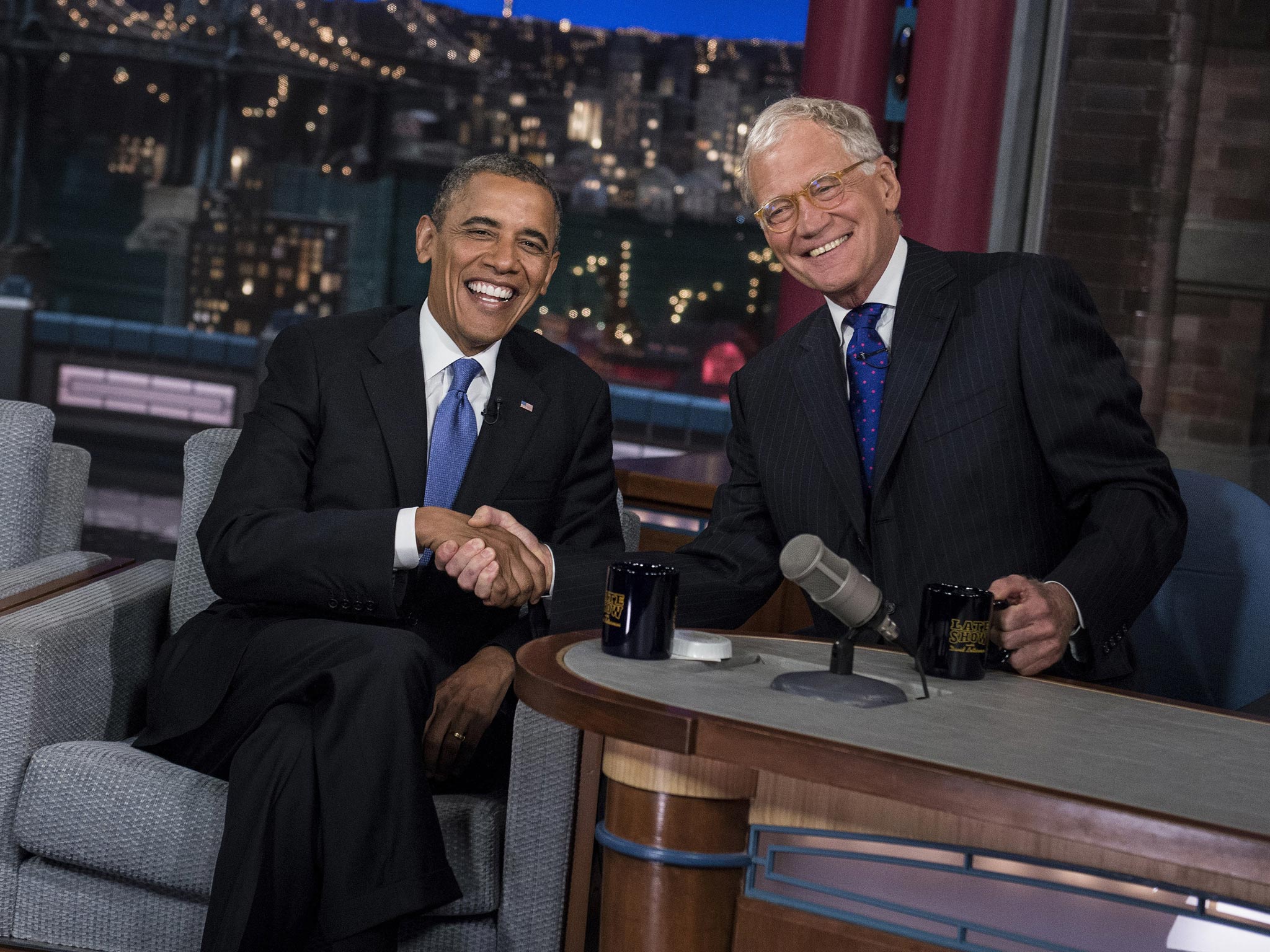 US President Barack Obama and David Letterman speak during a break in the taping