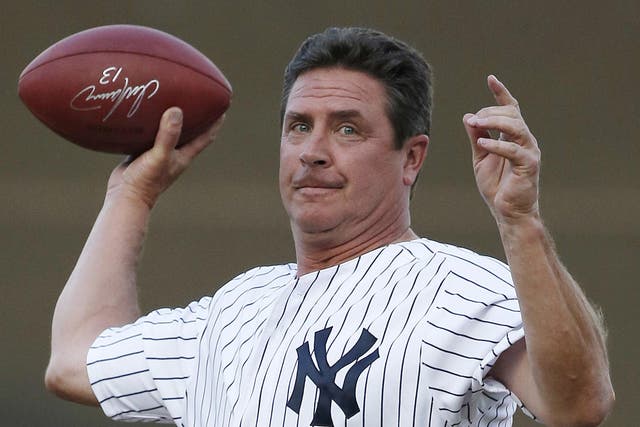Former Miami Dolphins quarterback Dan Marino throws an autographed football from the mound after throwing out the ceremonial first pitch 