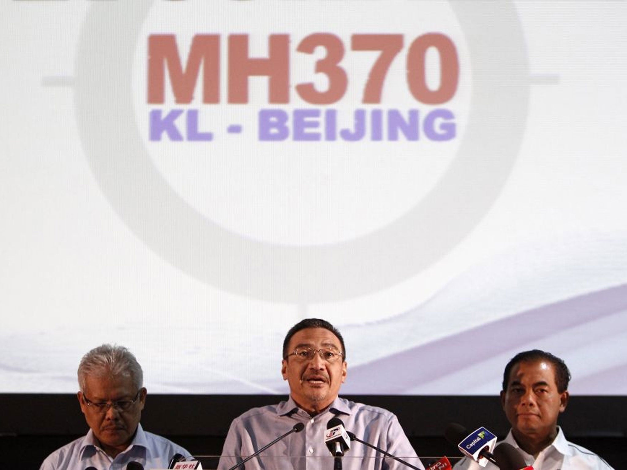 Malaysian acting Transport Minister Hishammuddin Hussein, center, speaks as Malaysian Deputy Foreign Minister Hamzah Zainuddin, left, and Malaysian Deputy Transport Minister Abdul Aziz Kaprawi listen during a press conference for the missing Malaysia Airl