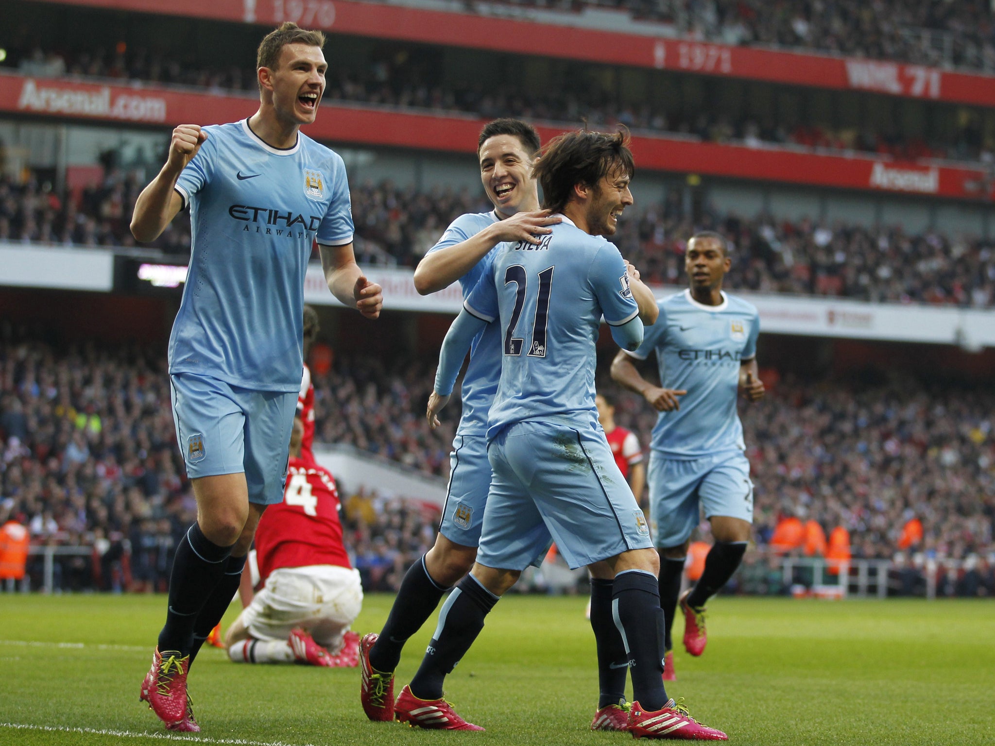 Edin Dzeko celebrates scoring against Arsenal