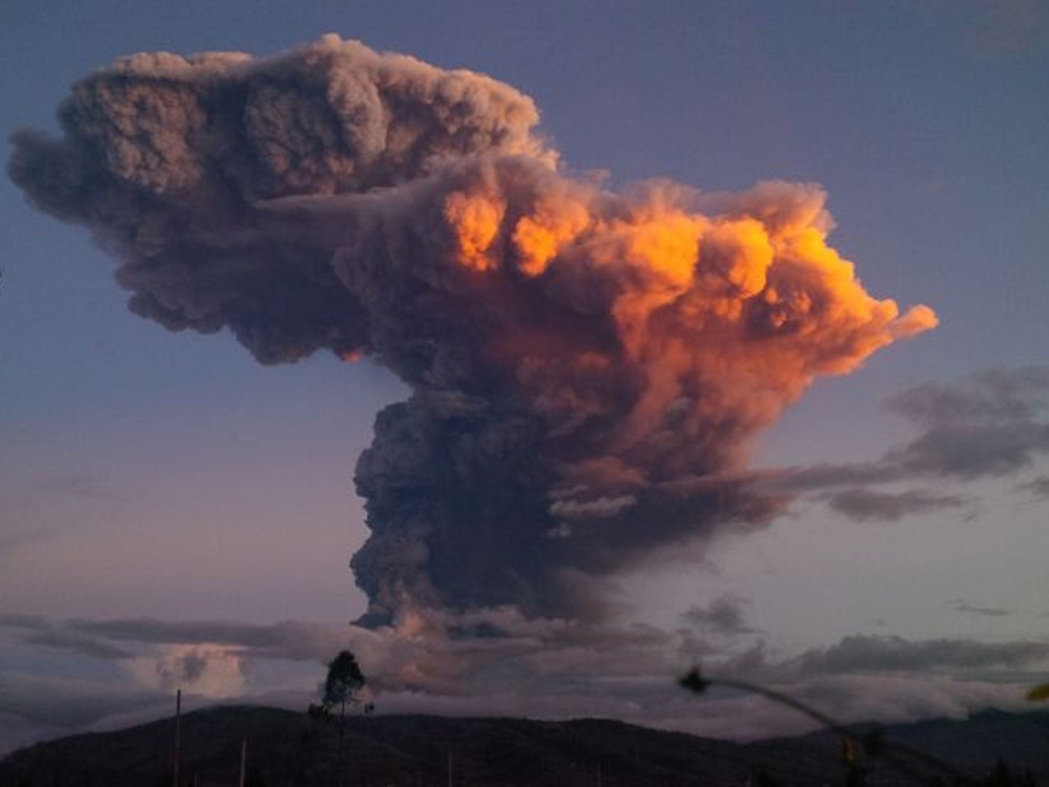 The Tungurahua volcano spews a column of ash as seen from Ambato, Ecuador, Friday, April 4, 2014. The volcano spewed a 6-mile (10-kilometer) column of ash after a powerful five-minute explosion that shot pyroclastic material onto its northern and northwes