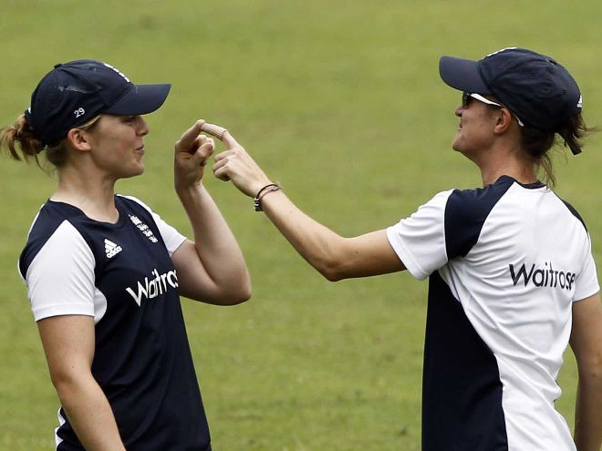 Finger on pulse: England bowler Jodie Dibble (left) finds a novel way of connecting with her team-mate