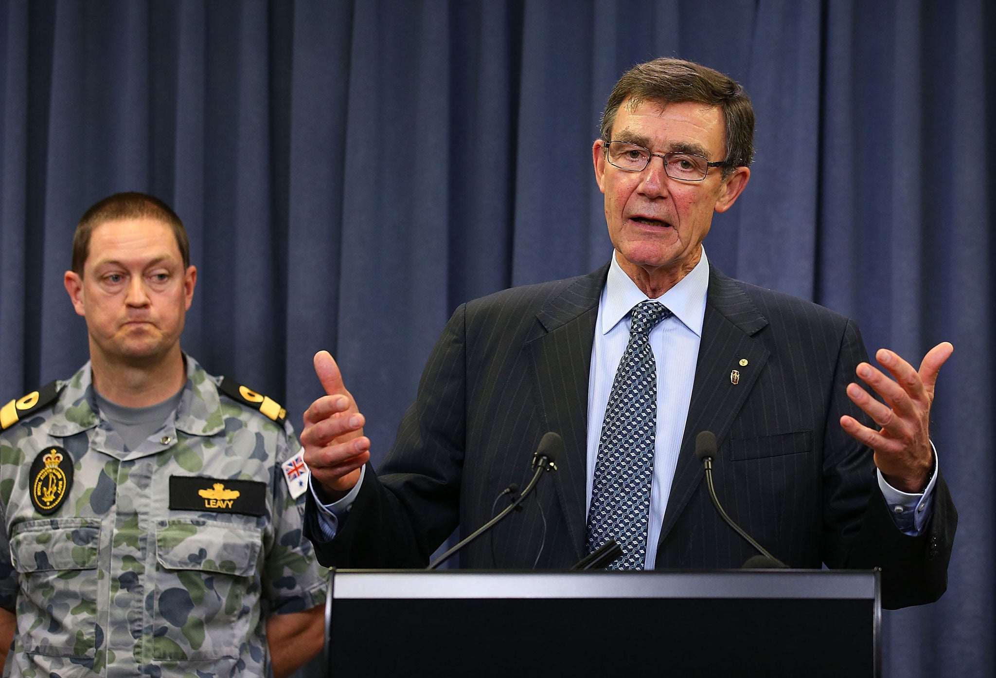 Retired Air Chief Marshal Angus Houston (right) addresses the media in Perth