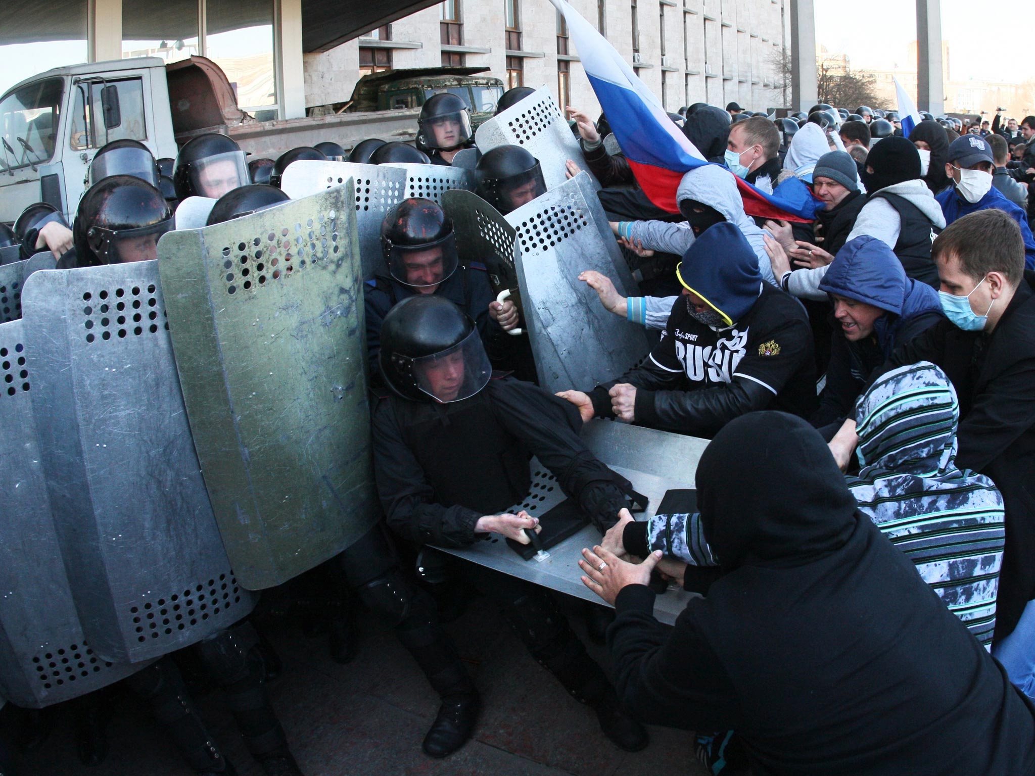 Pro-Russian supporters clash with members of the riot police as they storm the regional administration building