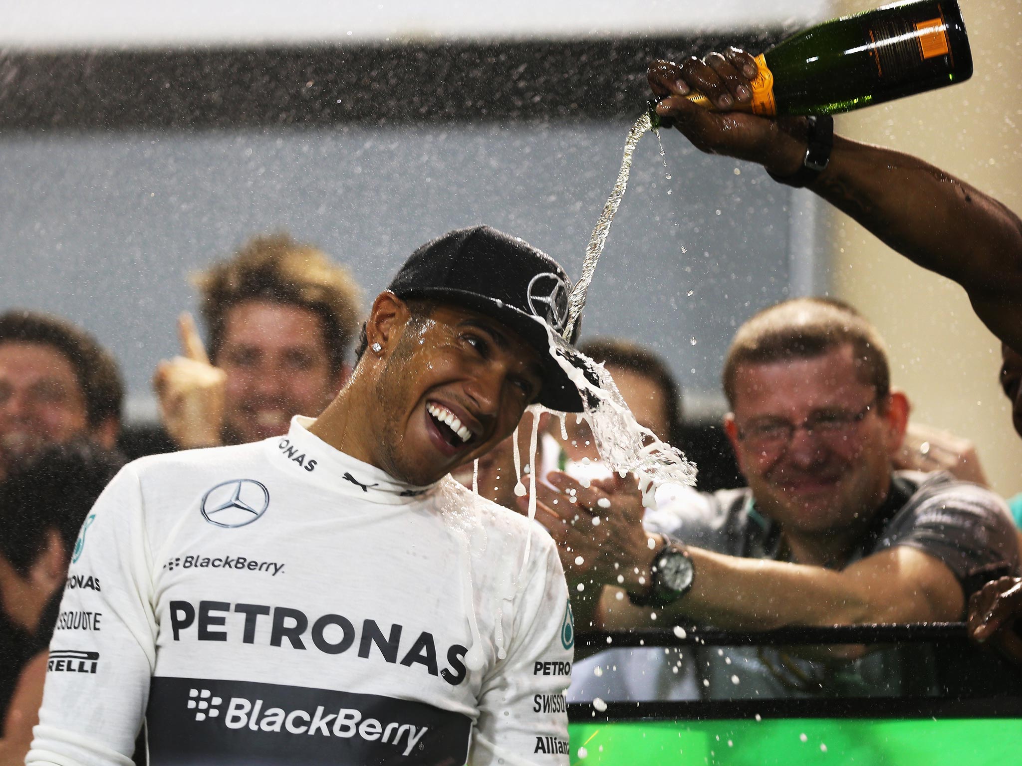 Lewis Hamilton celebrates his victory at the Bahrain Grand Prix with his Mercedes mechanics