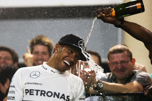 Lewis Hamilton celebrates his victory at the Bahrain Grand Prix with his Mercedes mechanics