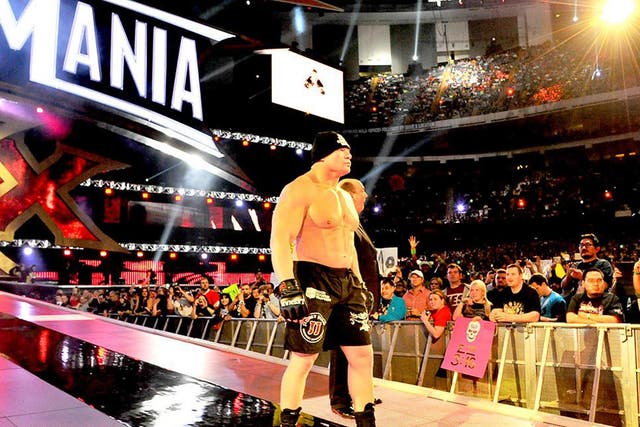 Brock Lesnar heads to the ring for his showdown with The Undertaker, accompanied by Paul Heyman