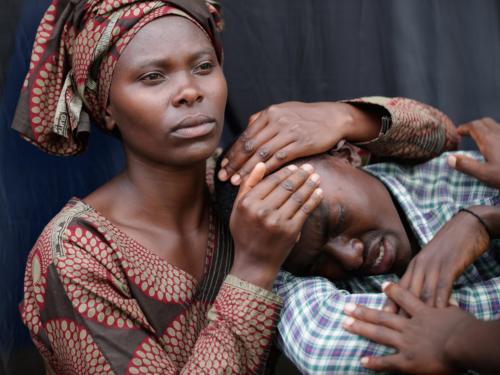 Mourners at the ceremony in Kigali, where Rwandan President
Paul Kagame renewed his accusations that France had been
complicit in the massacre of 800,000 people