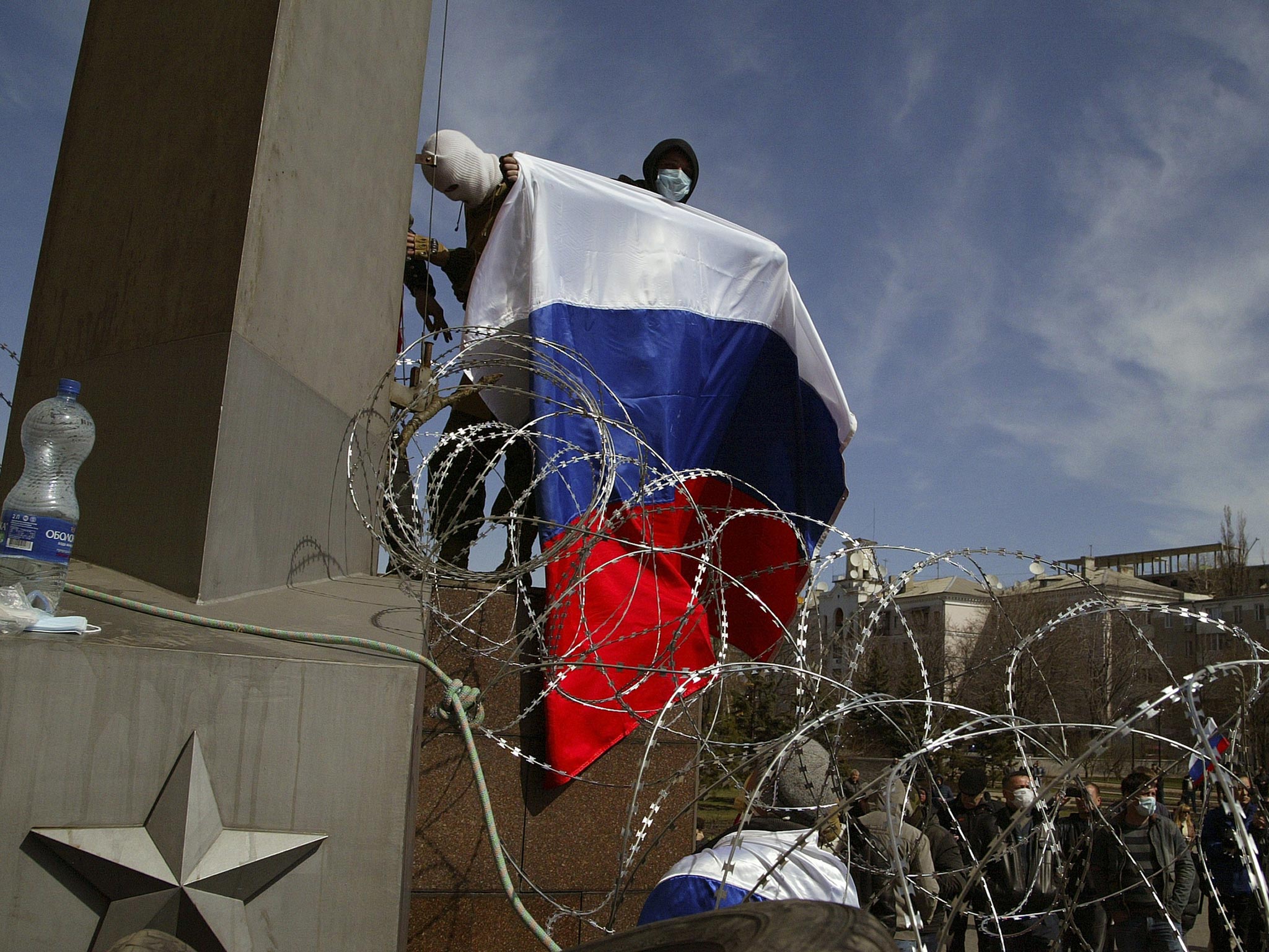 An activist holds Russia’s national flag above a barricade in the eastern city of Donetsk yesterday