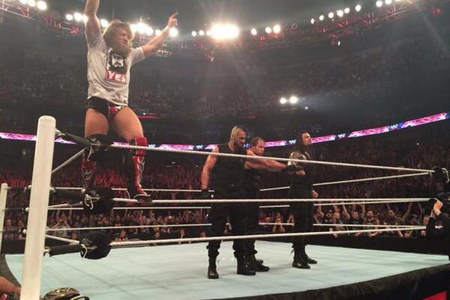 Daniel Bryan stands tall in the ring after The Shield help him to defeat Triple H