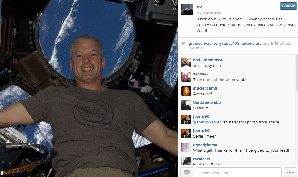 American astronaut Steven Swanson floating in the cupola of the ISS