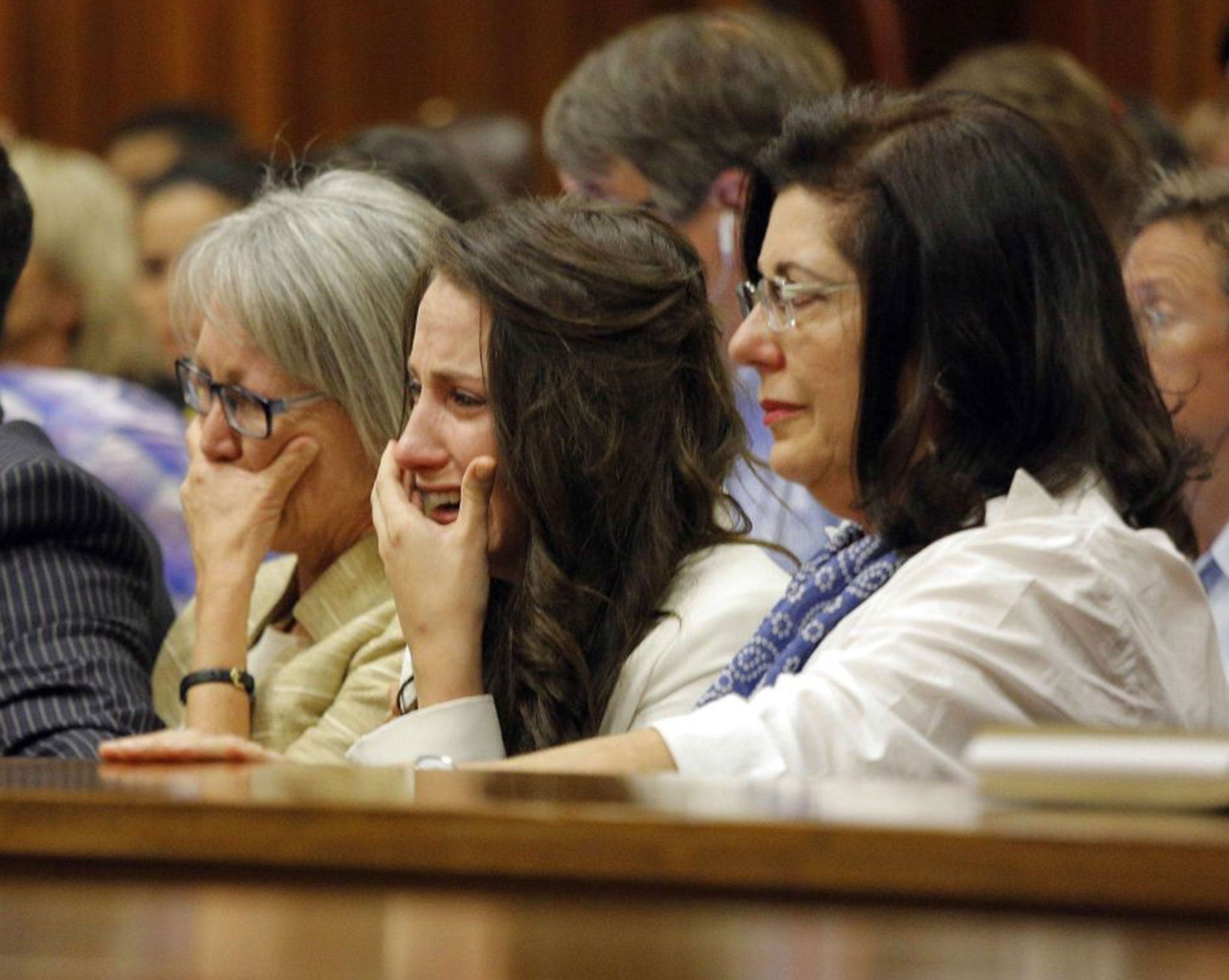 Aimee Pistorius (second right), Oscar's sister, cries as the athlete gives evidence
