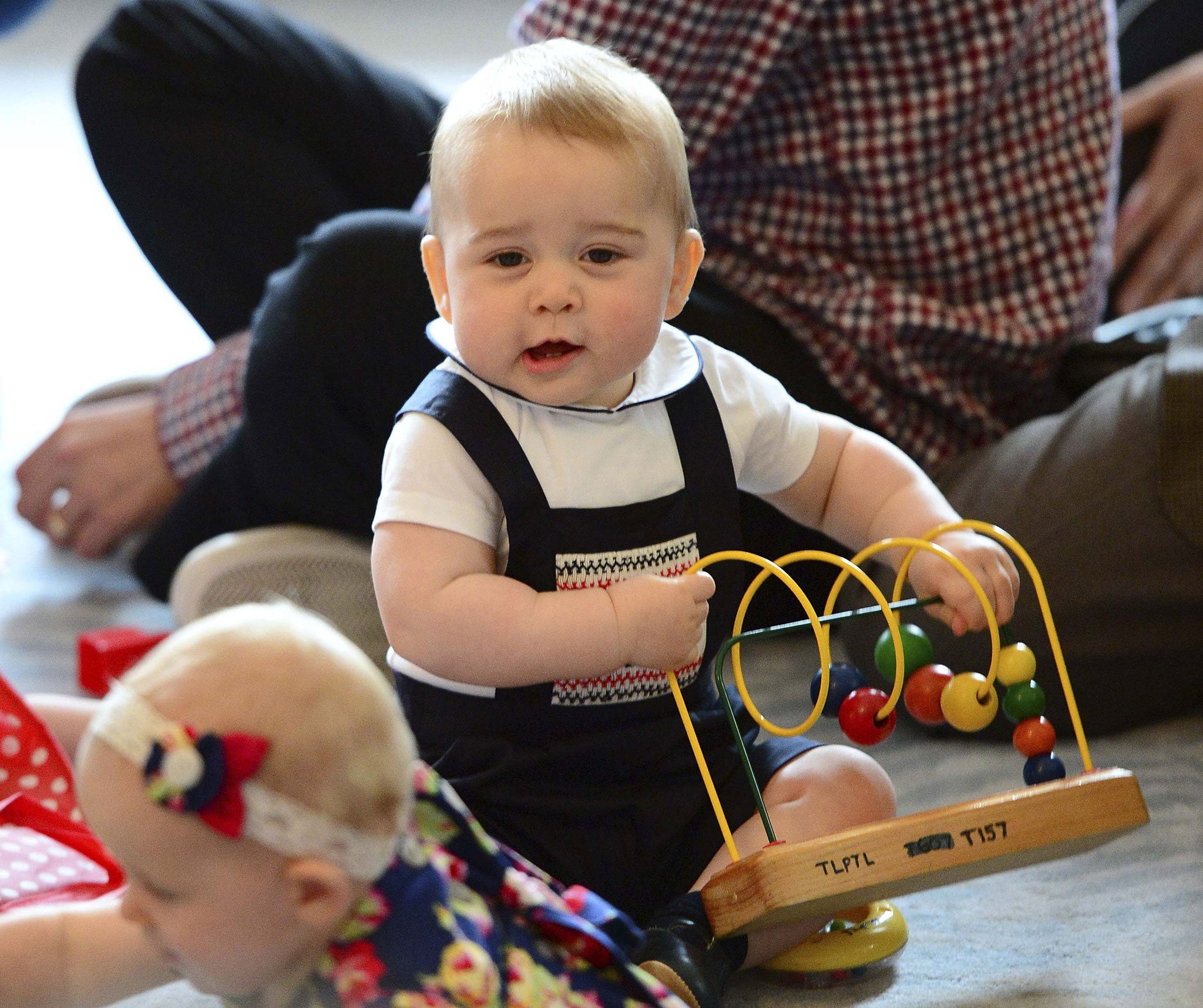 Prince George plays with a toy at a Plunket play group event at the Government House in Wellington