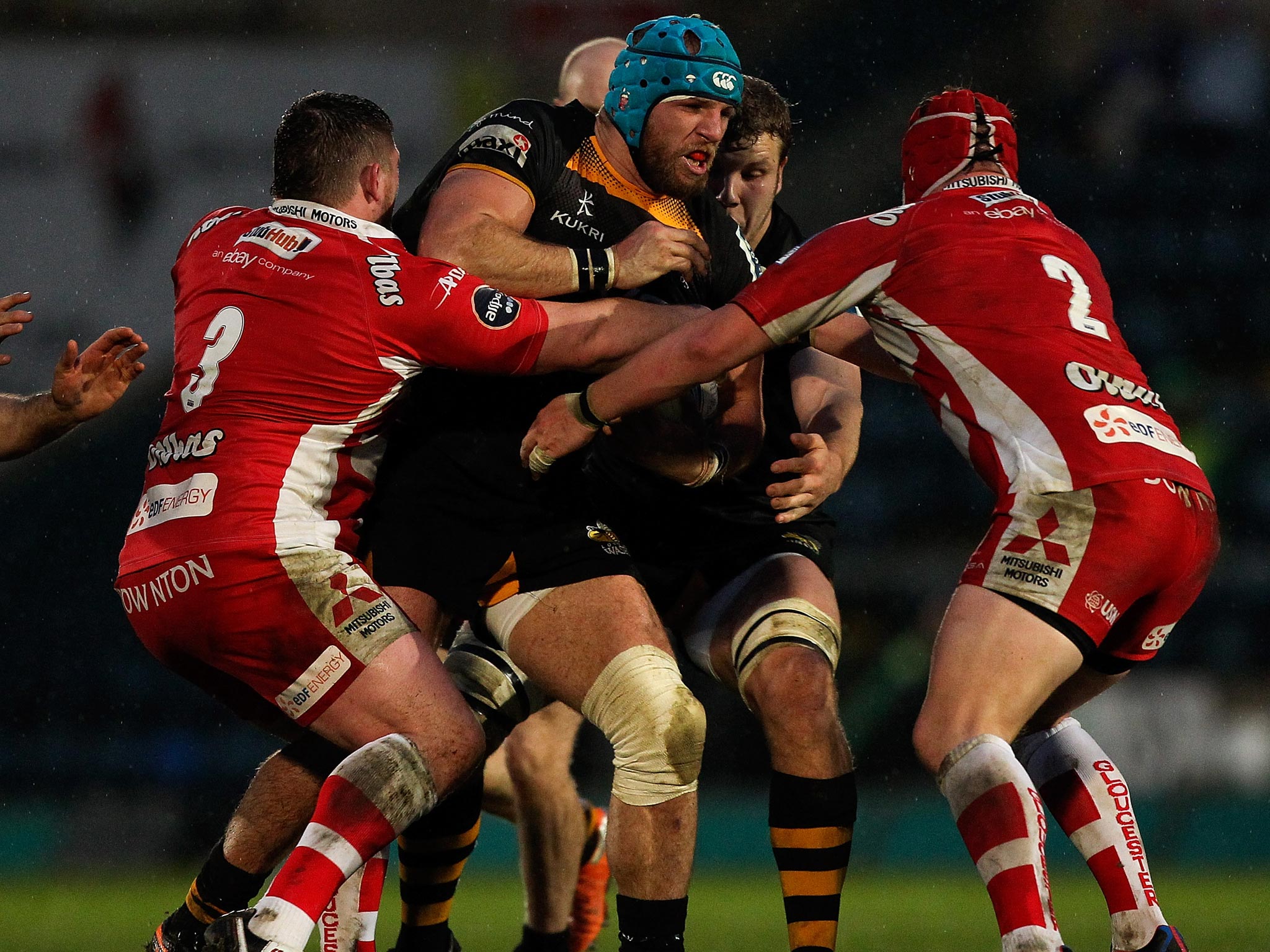 James Haskell of Wasps is tackled by Shaun Knight (L) and Daniel George (R) of Gloucester during the Amlin Challenge Cup Quarter Final