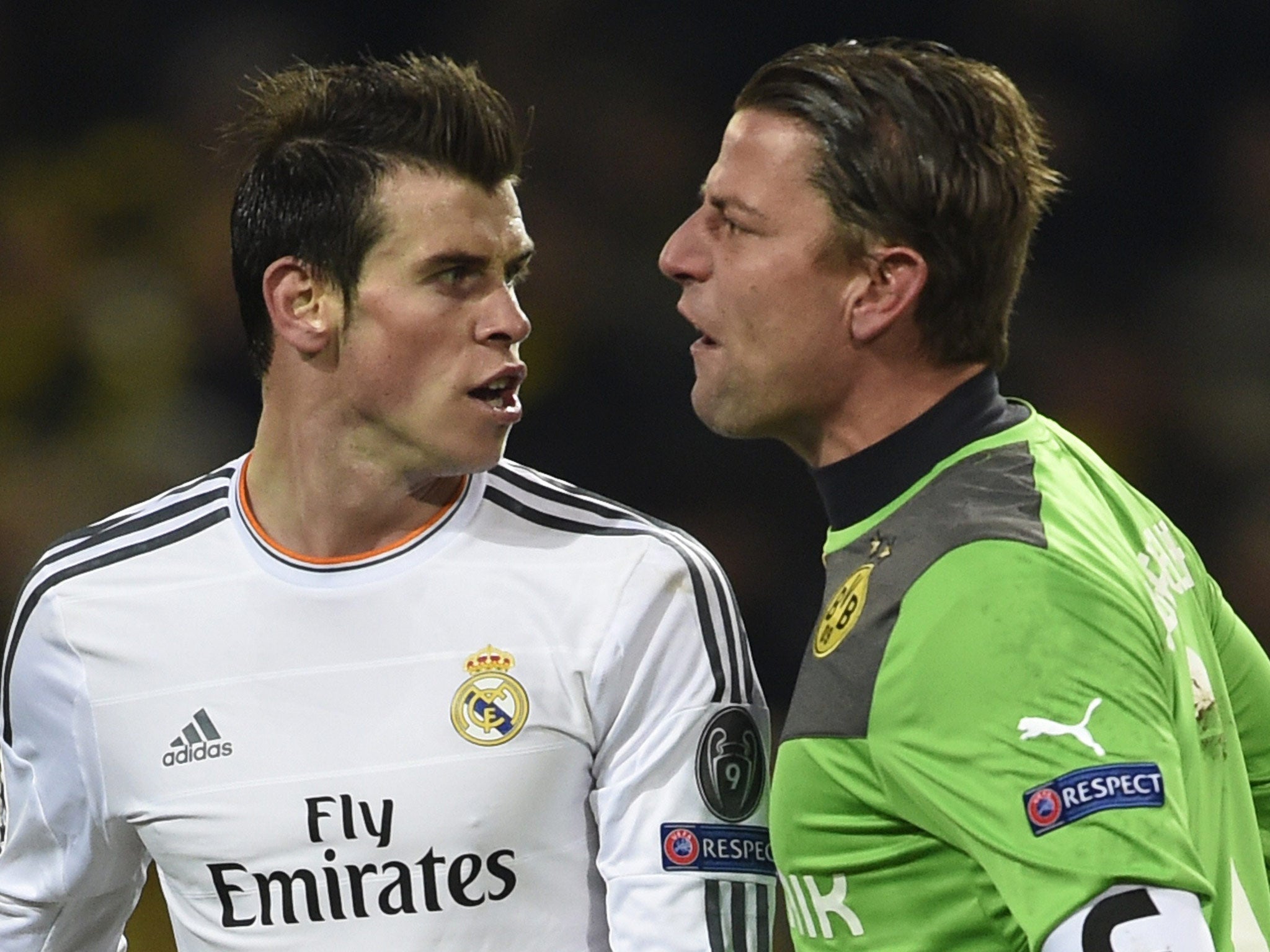 Dortmund's goalkeeper Roman Weidenfeller (R) and Real Madrid's Welsh forward Gareth Bale exchange words following a clash during their Champions League meeting