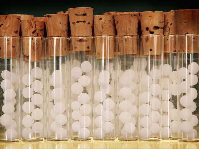 Vials containg pills for homeopathic remedies are displayed at Ainsworths Pharmacy on August 26, 2005 in London.