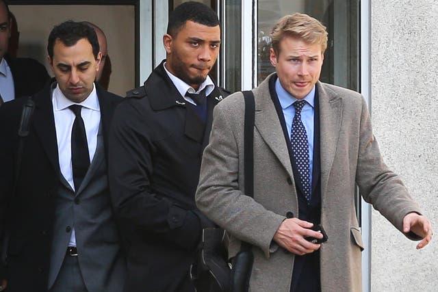 Colin Kazim-Richards (centre) leaves Brighton Magistrates Court in East Sussex