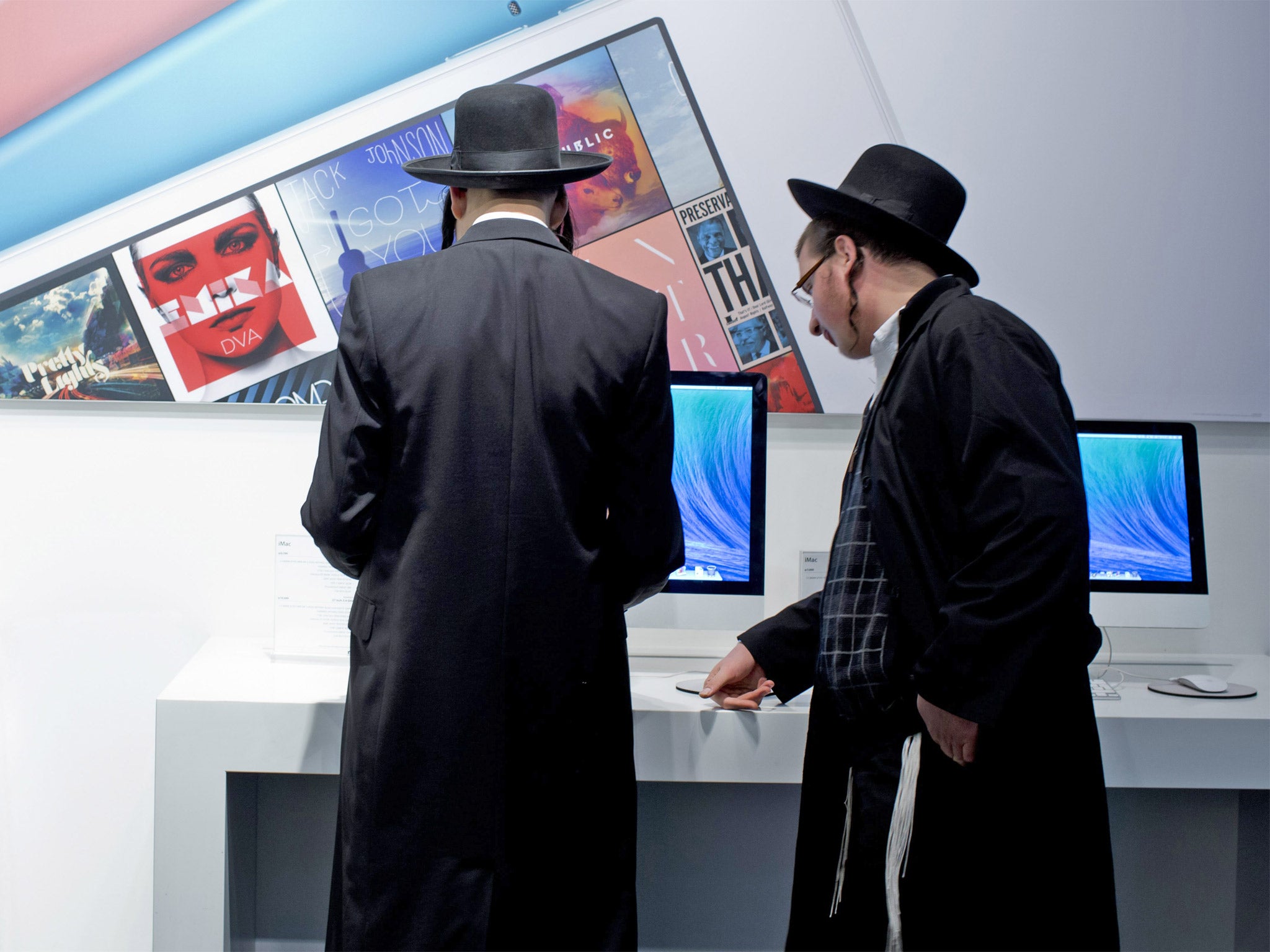 Ultra-Orthodox men browsing at an Apple store in Jerusalem