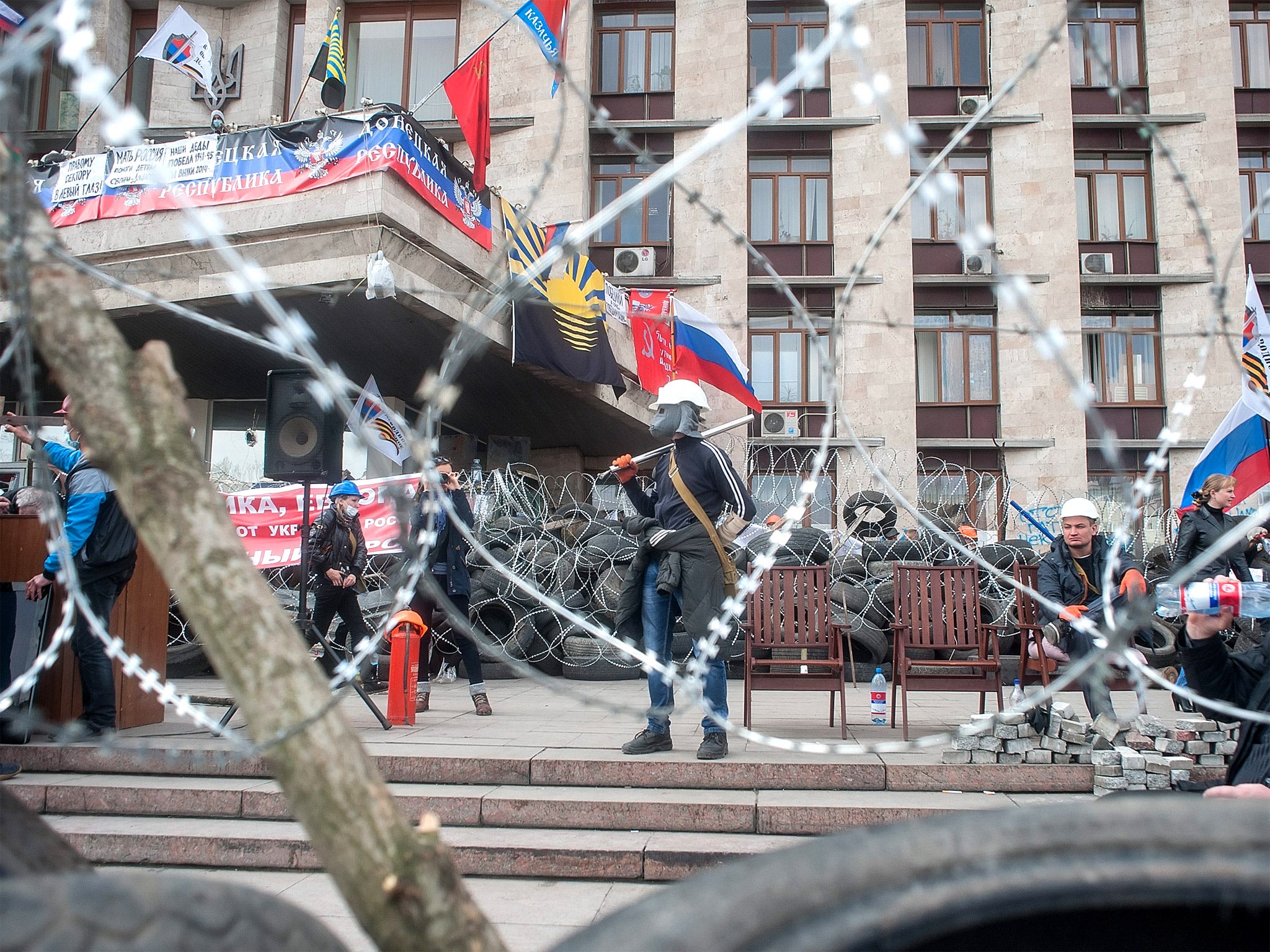 Masked pro-Russian activists guard barricades at the regional administration building in Donetsk