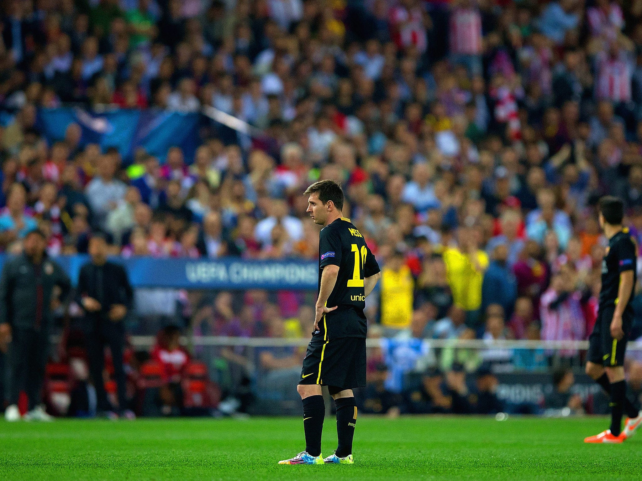 A dejected Lionel Messi of Barcelona looks on during the Champions League defeat to Atletico Madrid