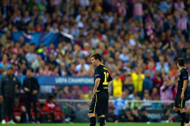 A dejected Lionel Messi of Barcelona looks on during the Champions League defeat to Atletico Madrid
