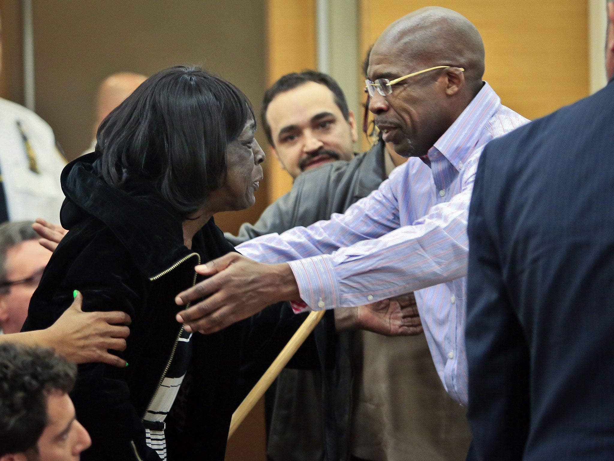 Jonathan Fleming, left, reaches to hug his mother Tricia Fleming in Brooklyn's Supreme court