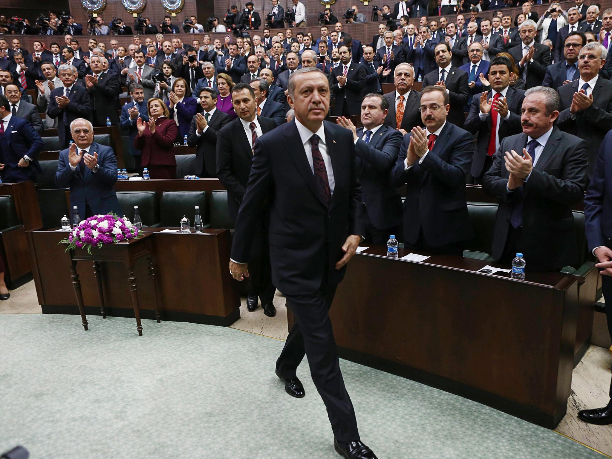 Recep Tayyip Erdogan (centre) greeted by MPs from his Justice and Development (AKP) Party; his government shut down social media over a corruption scandal before recent elections