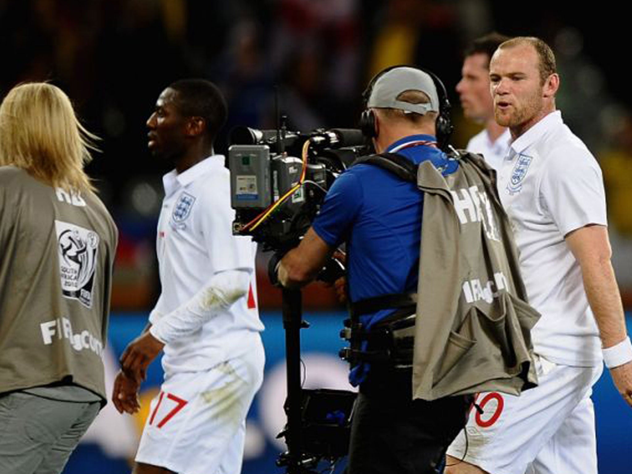 Wayne Rooney of England speaks to a cameraman as he walks off the pitch dejected after the 2010 Fifa World Cup South Africa Group C match between England and Algeria