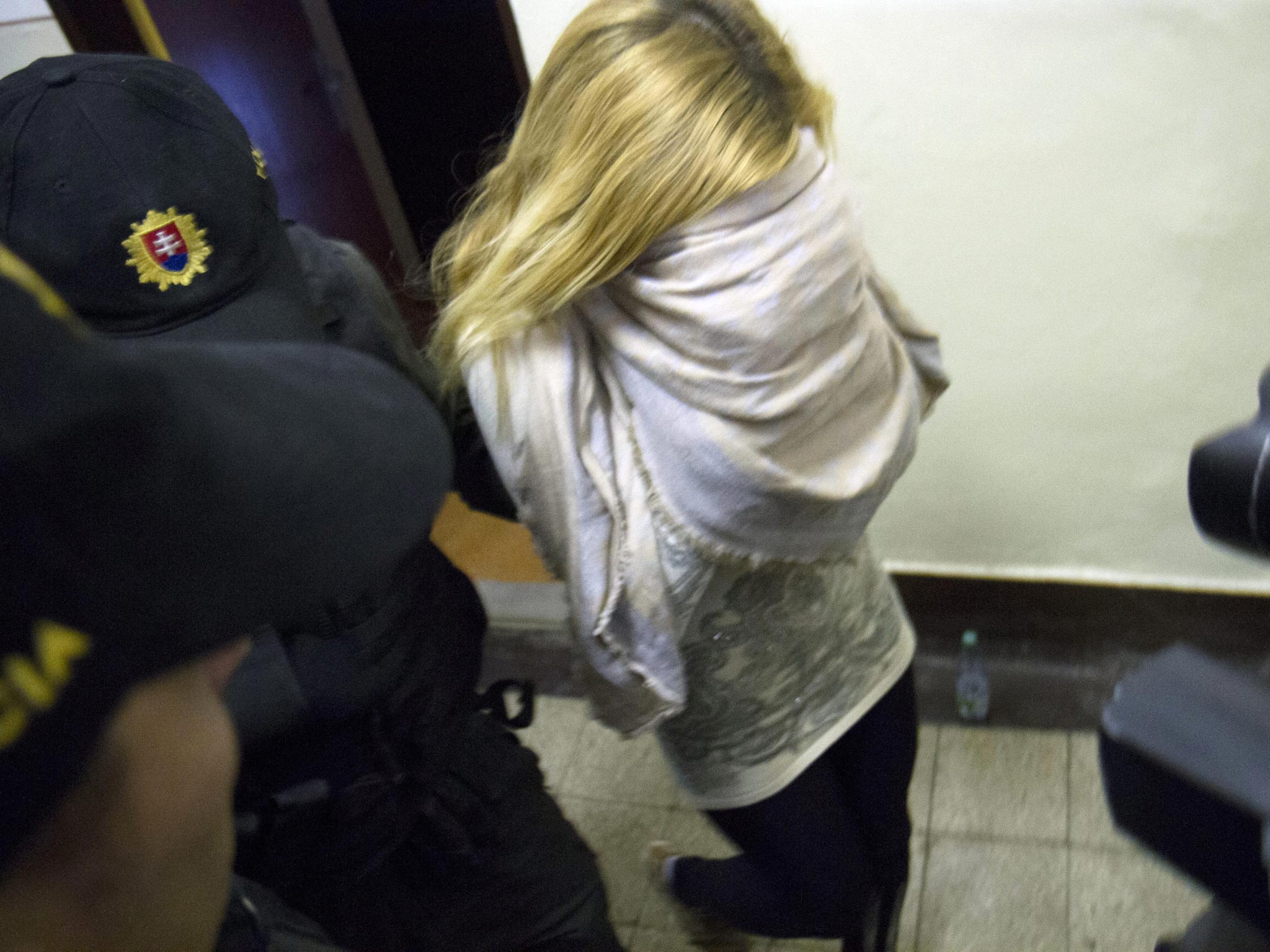 Slovakian model Mayka Marica Kukucova is escorted by the police from the Regional Court in Trencin, Slovakia