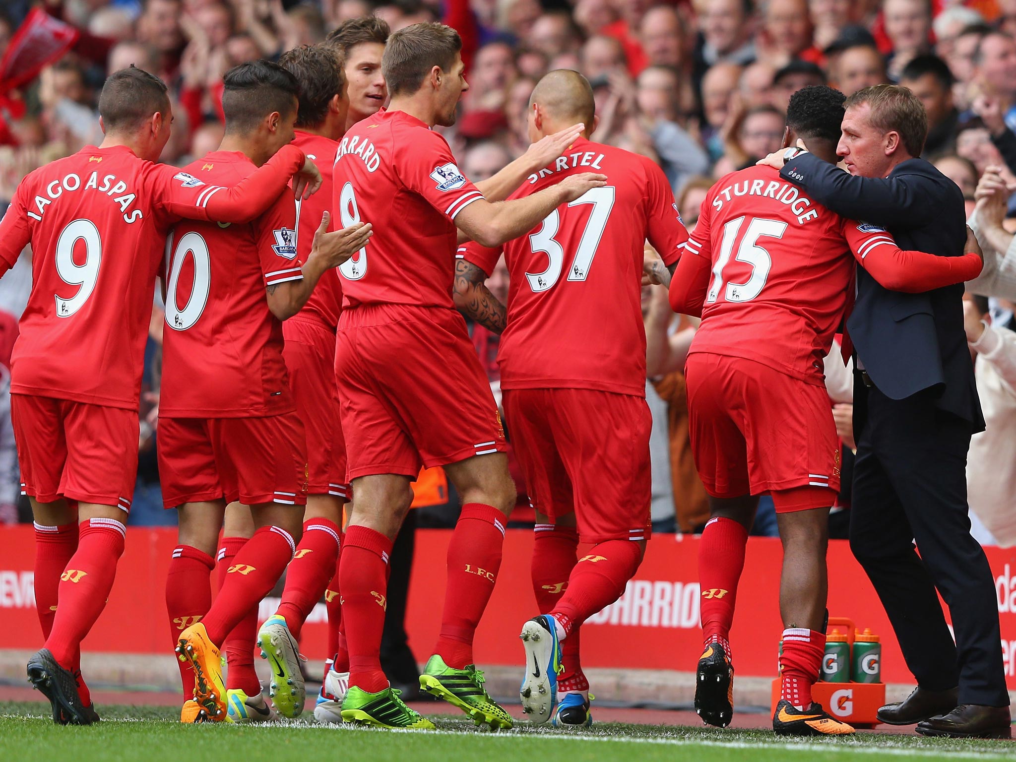 Liverpool’s players celebrate a goal with manager Brendan Rodgers at Anfield this season