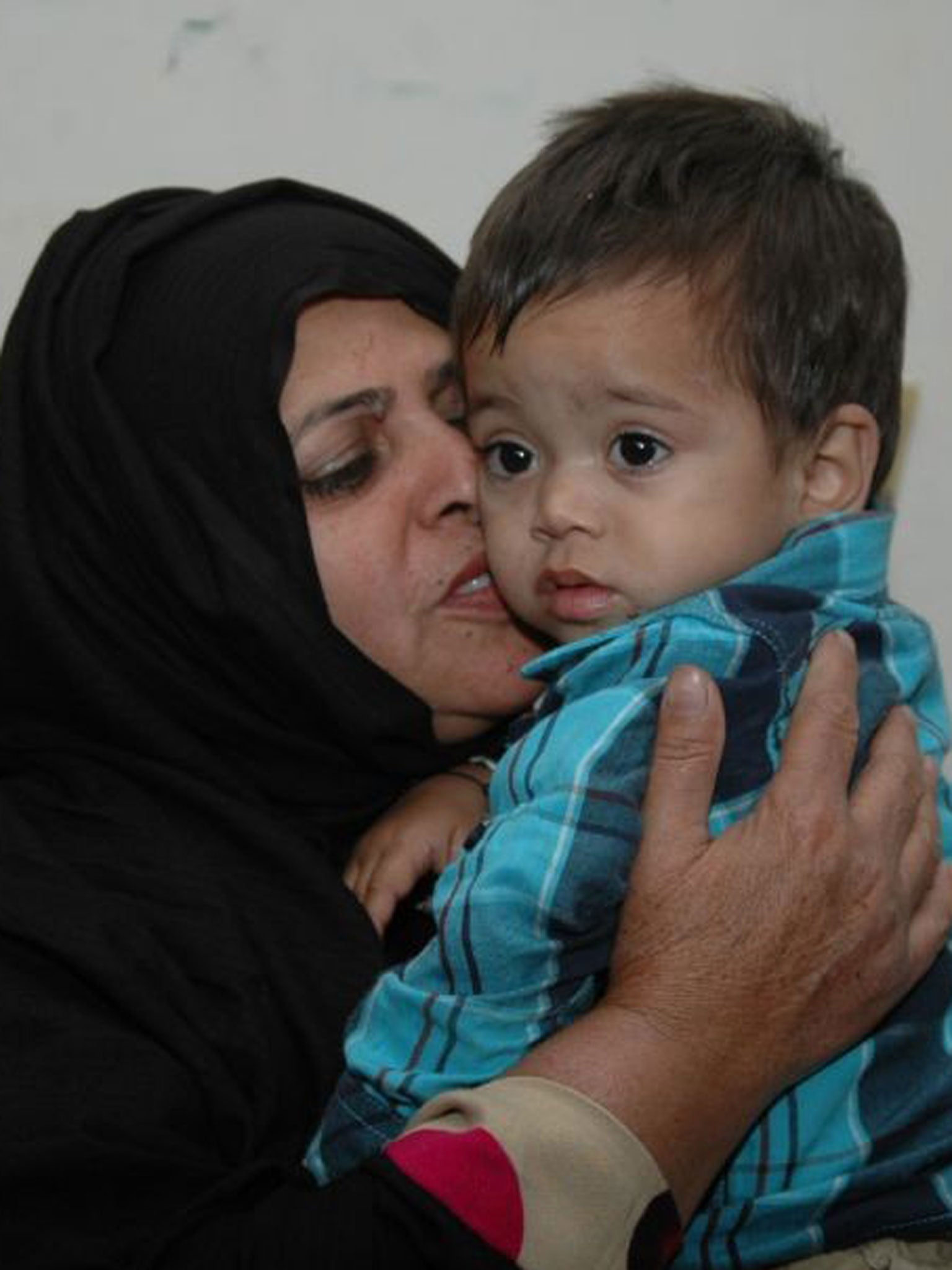 Nine-month-old baby Musa Khan is comforted in a lawyers office on 3 April