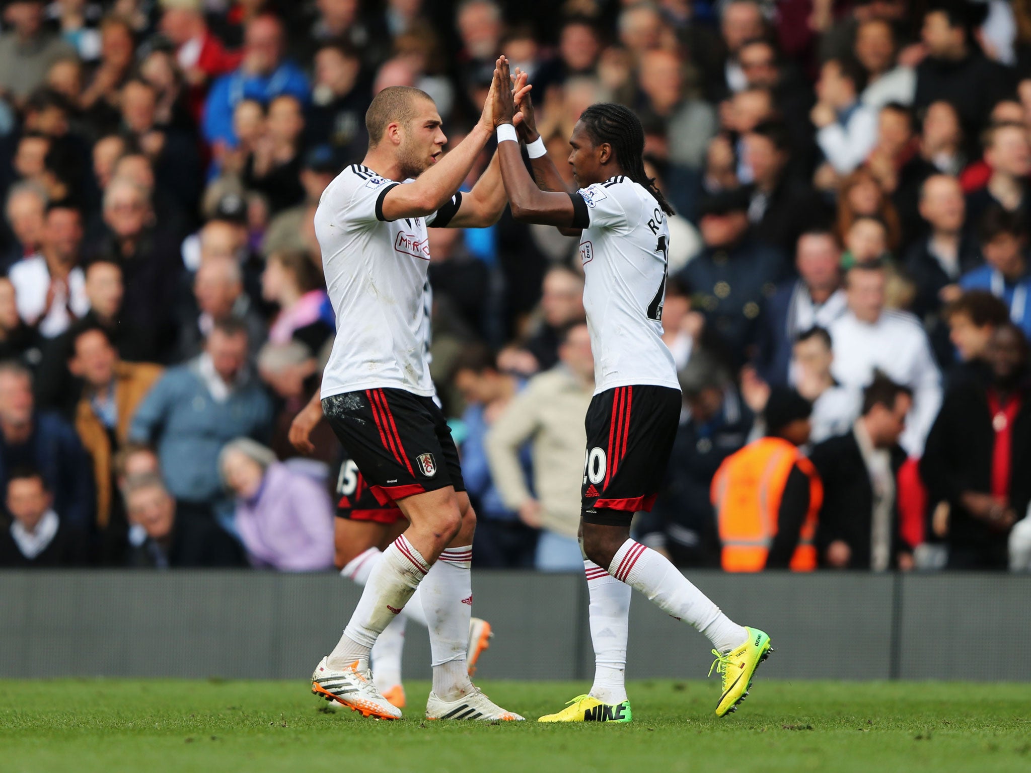 Hugo Rodallega of Fulham (R) celebrates with Pajtim Kasami as he scores their first goal